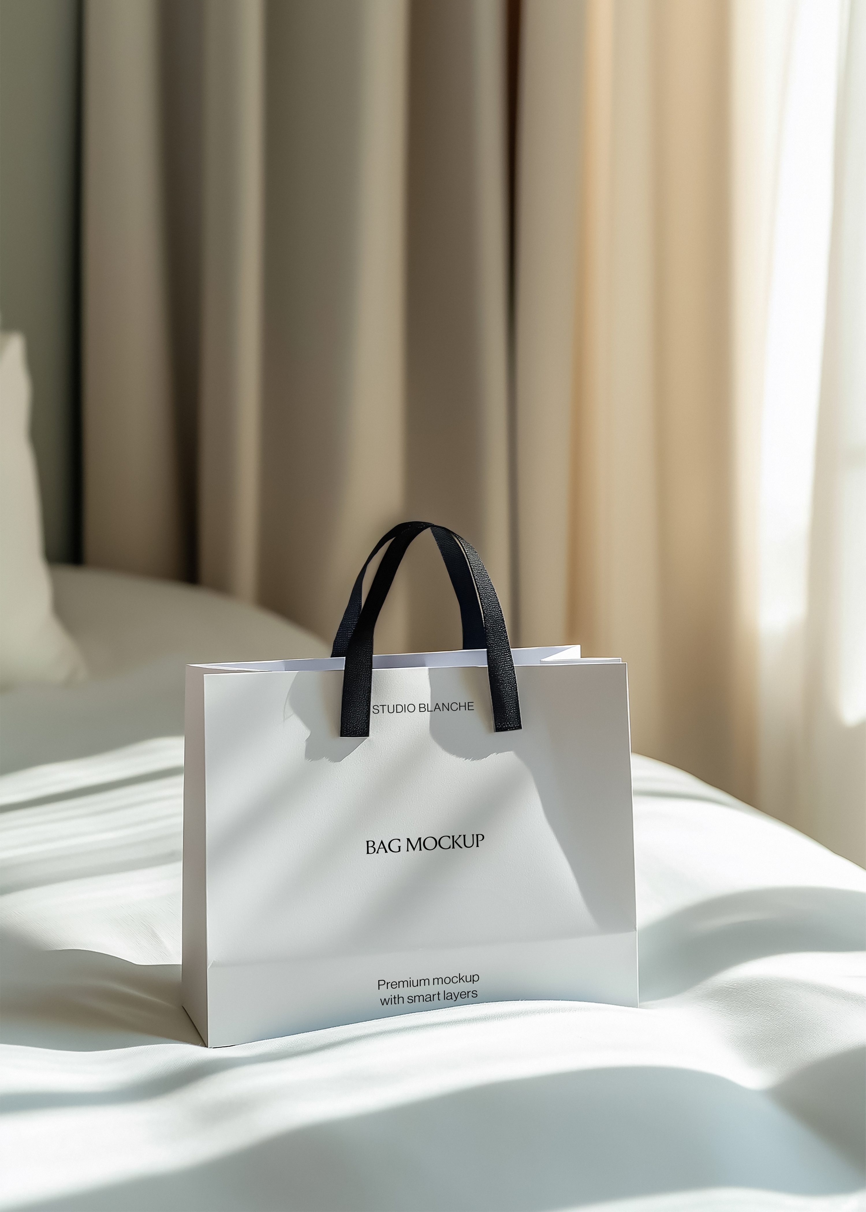 White paper shopping bag mockup with black handles on rippled white silk, beige curtains and sunlight behind