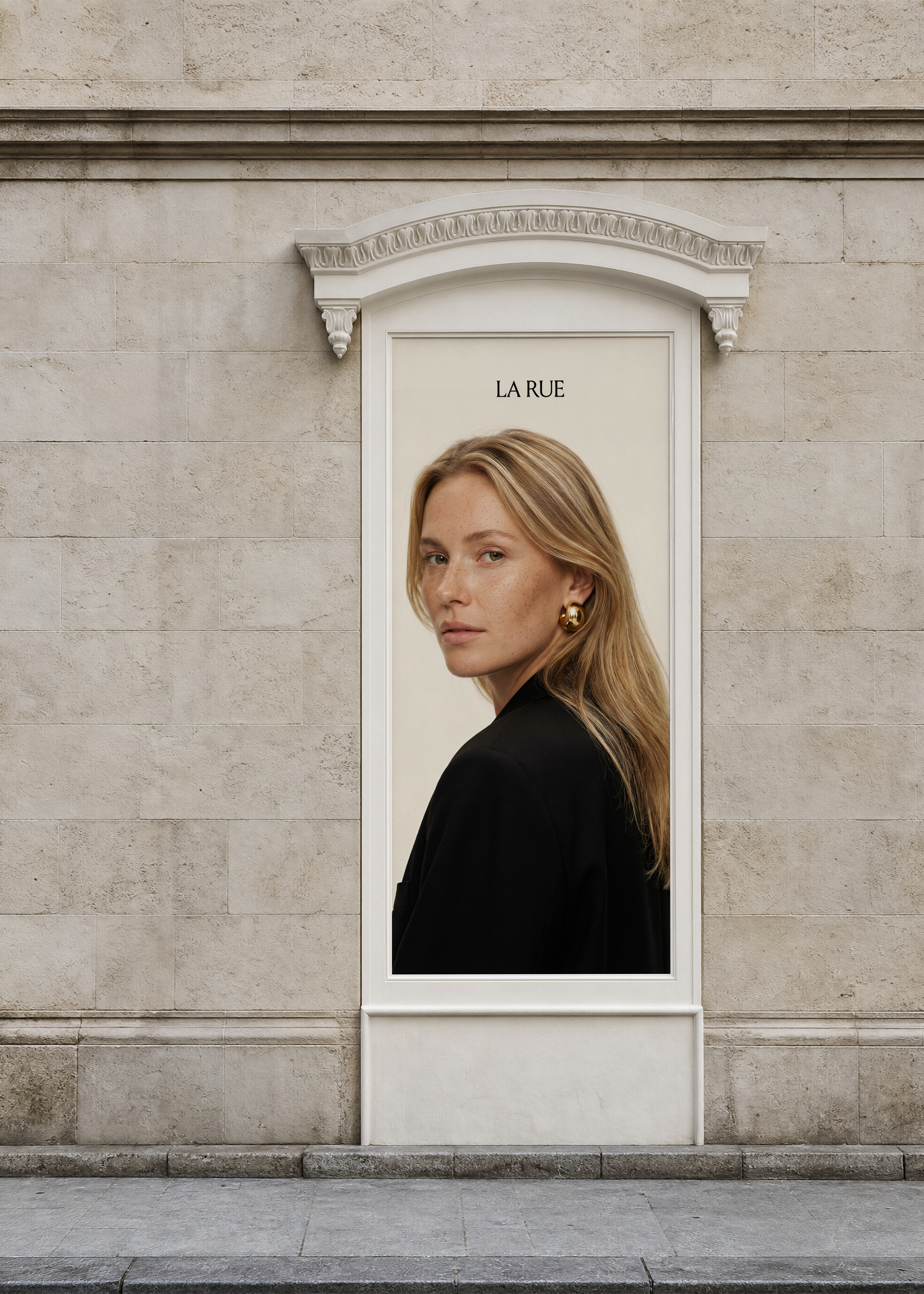 Vertical billboard mockup on limestone wall showing blonde model in black blazer, ornate white pediment