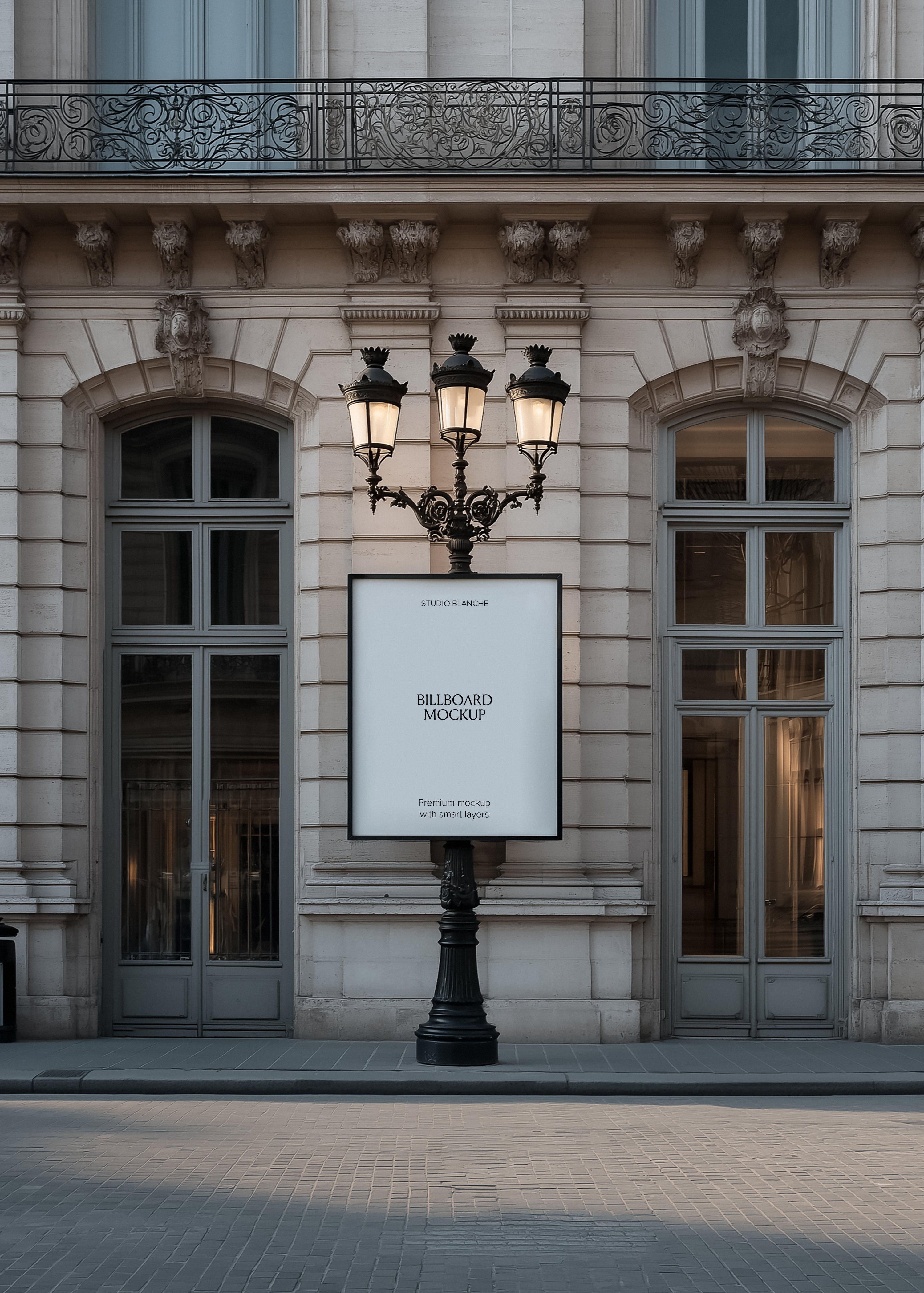 Blank lamp post billboard mockup on a Parisian street at dusk, empty white panel with Studio Blanche label