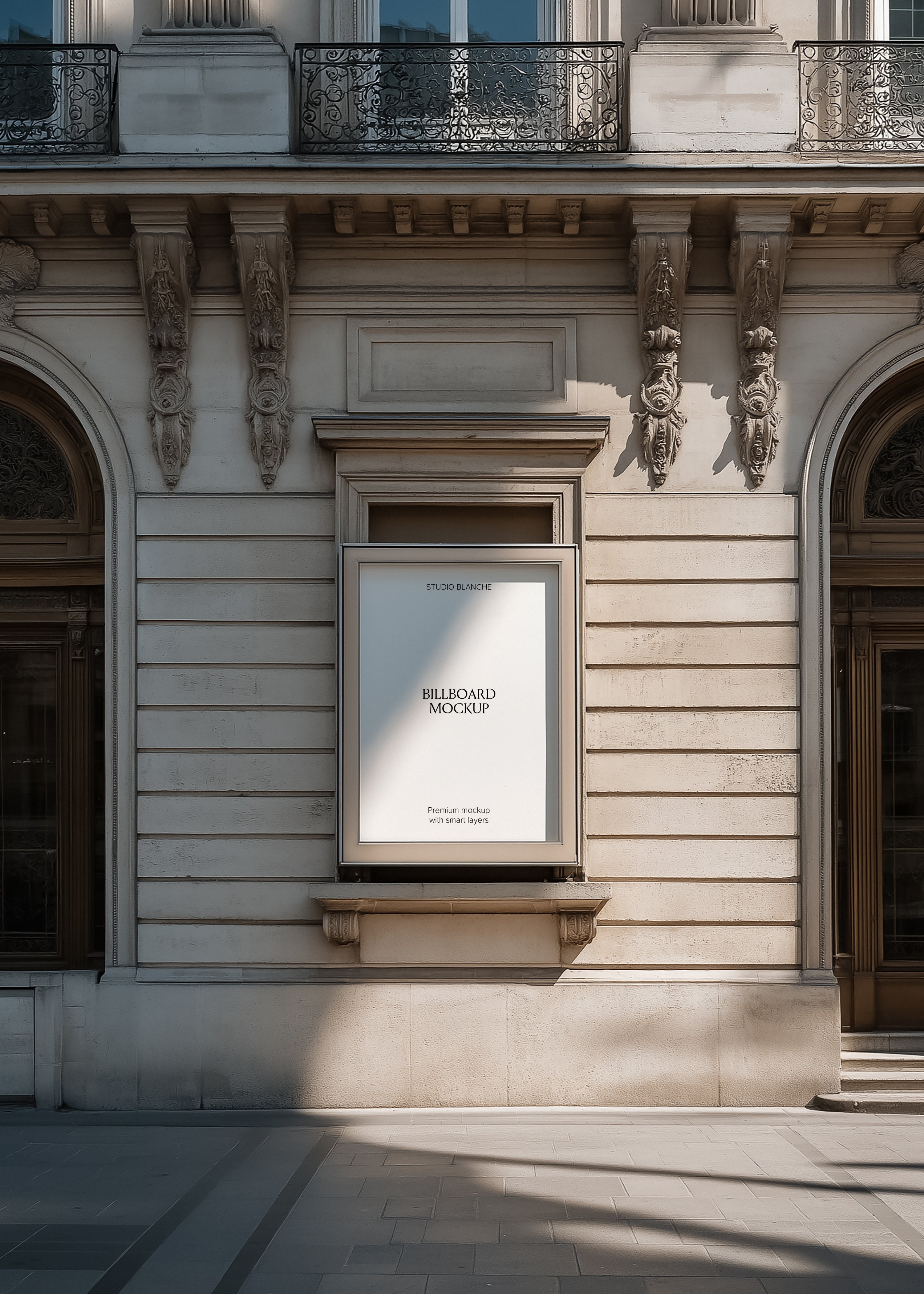 Blank window billboard mockup in a stone recess on a Haussmann facade, empty white panel with Studio Blanche label