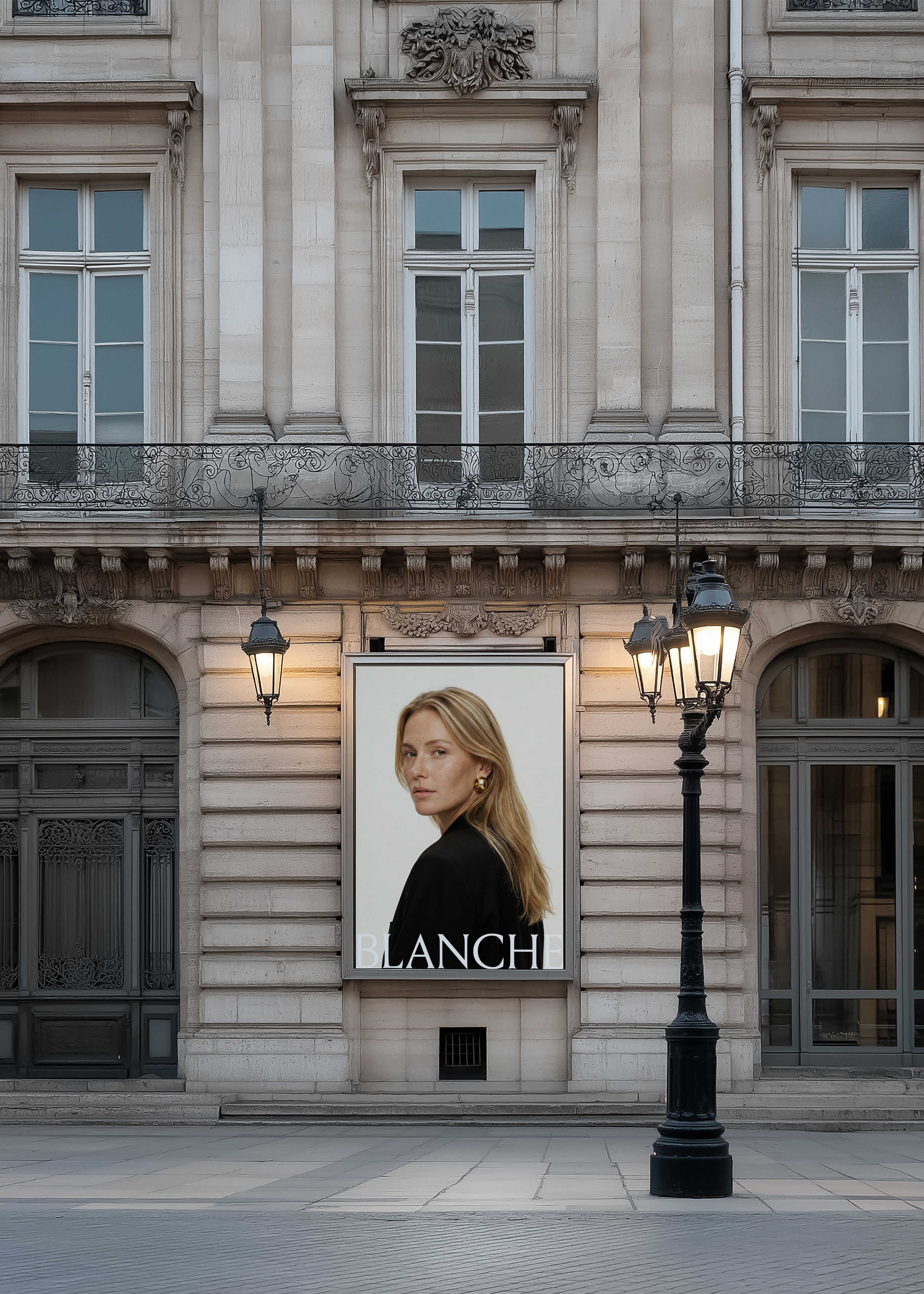 Facade billboard mockup on a Haussmann building at dusk beside cast iron lamp posts, displaying fashion campaign