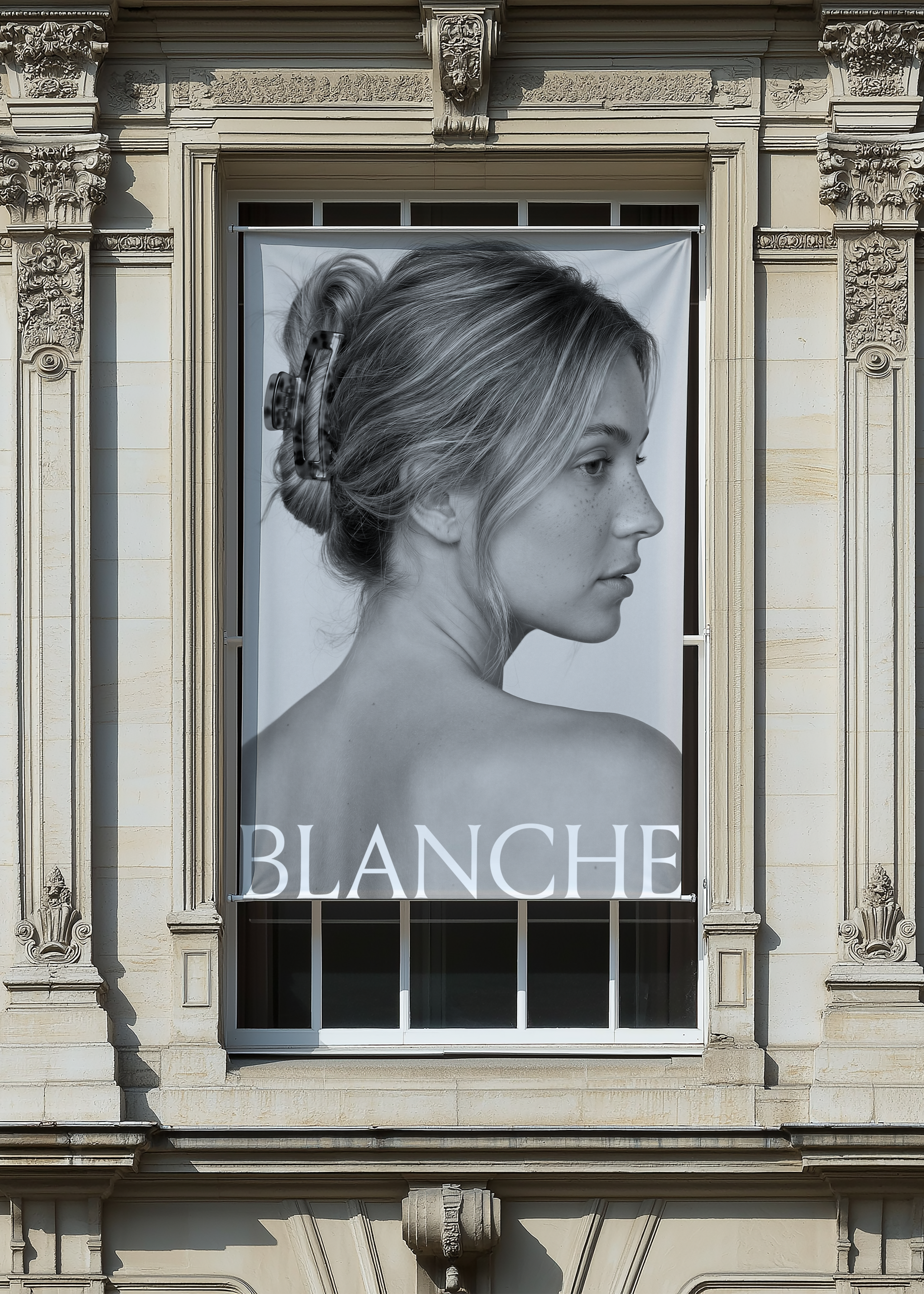 Window billboard mockup on a French stone facade in sunlight, banner displaying black and white fashion campaign