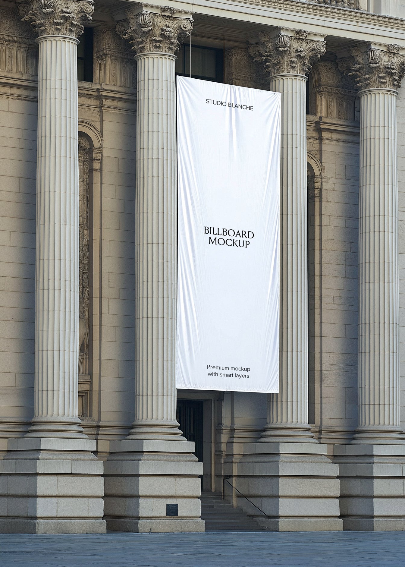 Blank tapestry billboard mockup suspended between Corinthian columns, empty white banner with Studio Blanche label
