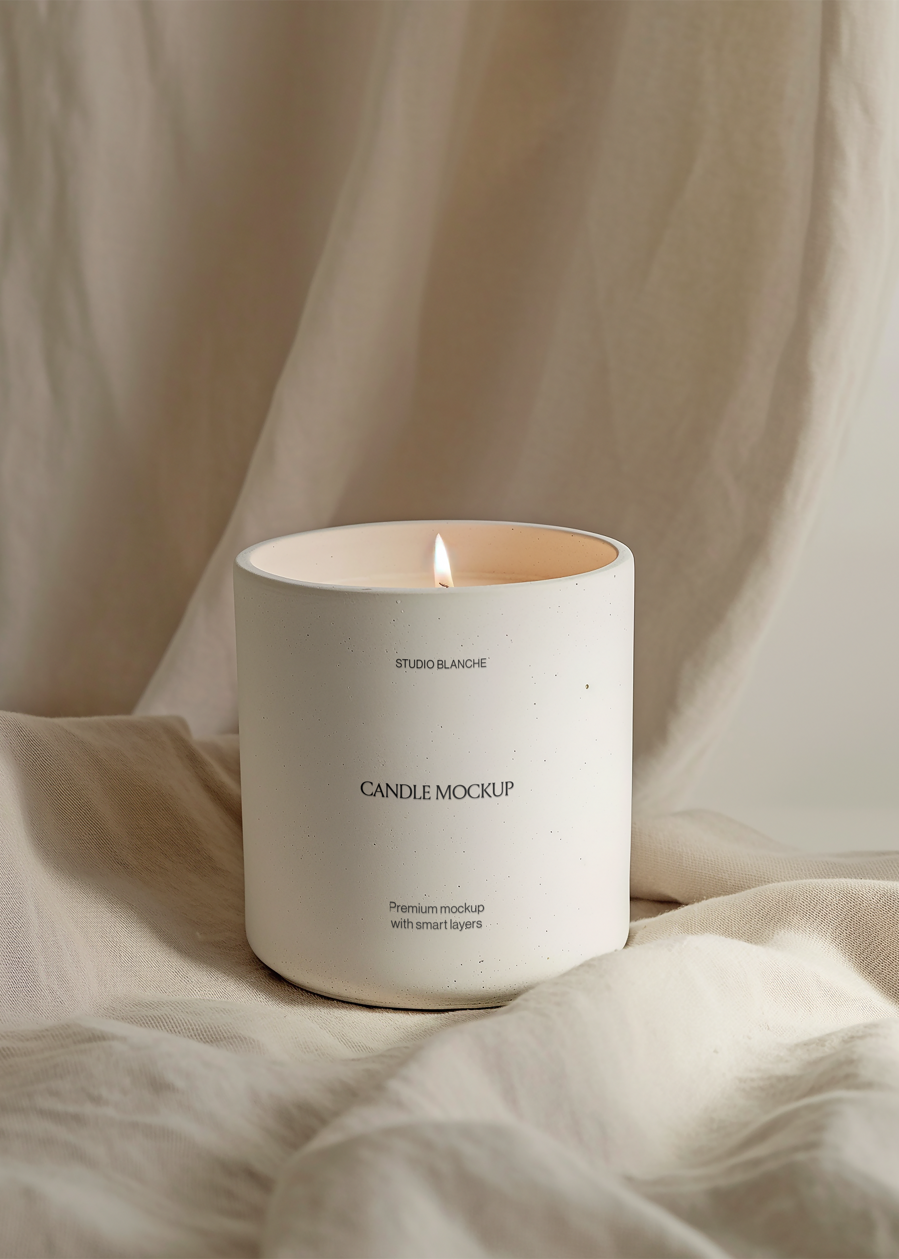 Studio Blanche concrete candle mockup, matte vessel on linen with full draped fabric background, single flame