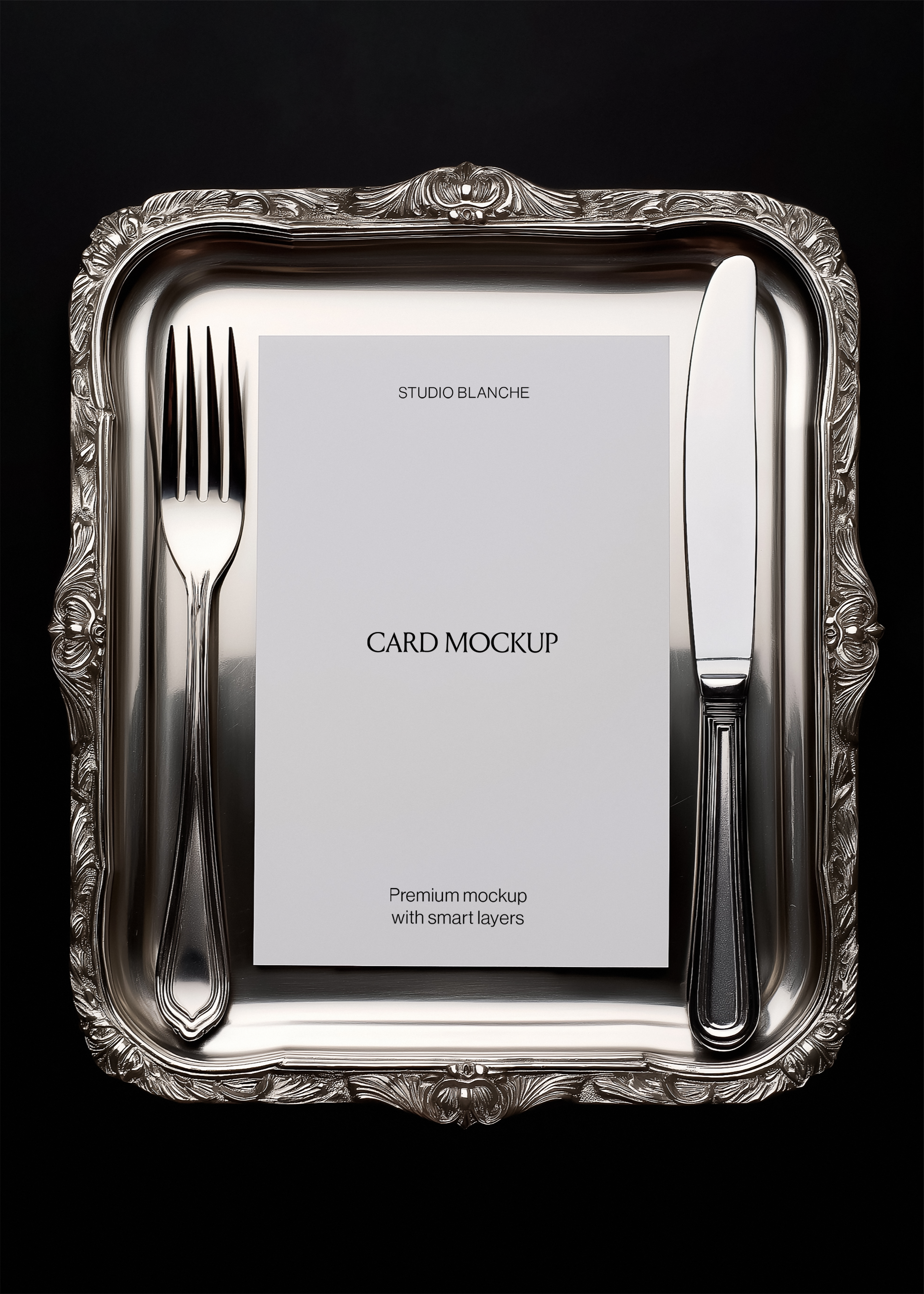 Card mockup detail on ornate rectangular silver tray showing scroll cartouche, cutlery, white card with black text