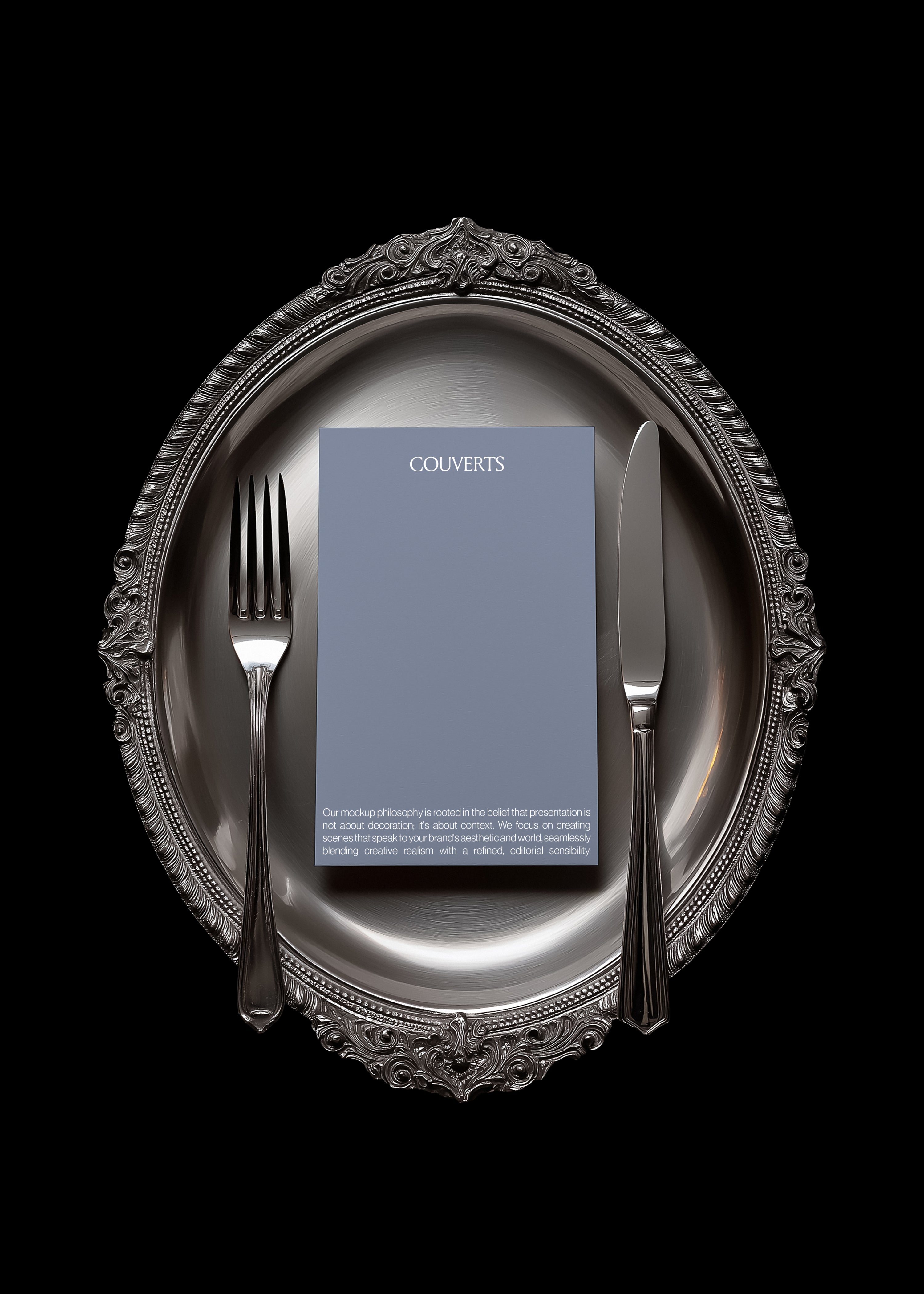Portrait card mockup centred on ornate scalloped silver charger with fork and knife either side, black background, vintage styling