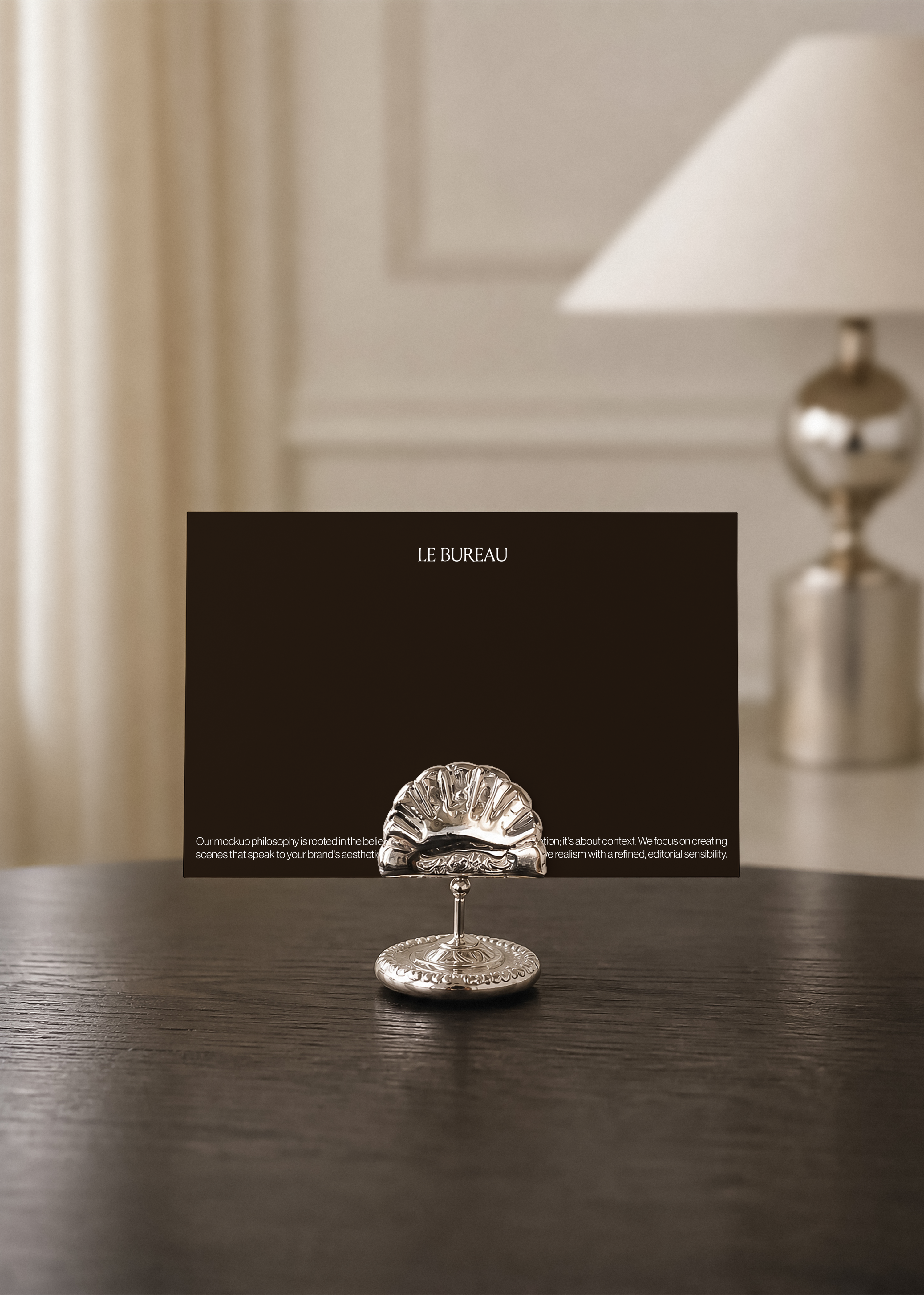 Dark brown card mockup with printed footer text, set in a decorative silver shell-shaped holder