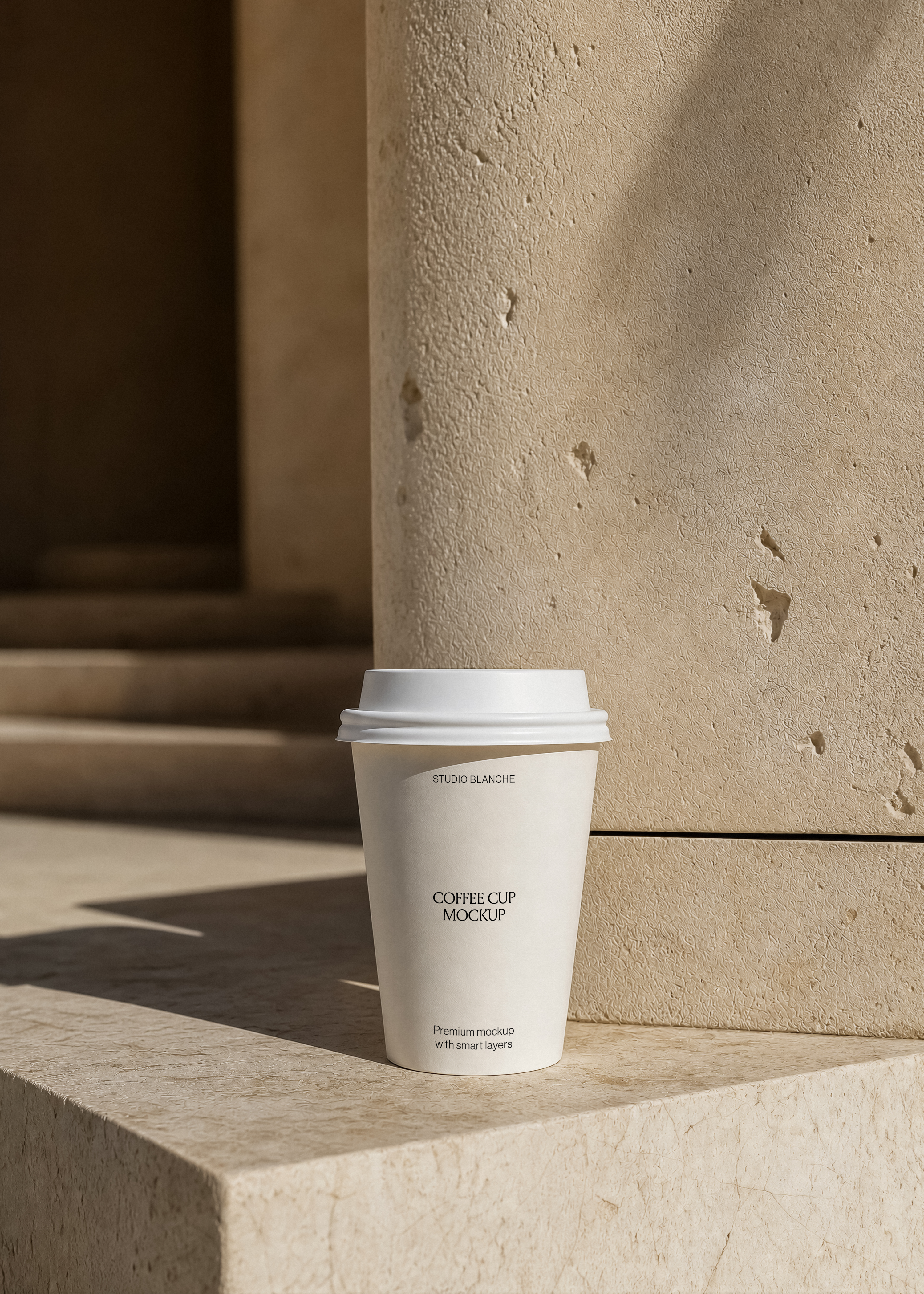 Coffee cup mockup showing centred café label text, cream paper cup and lid, beige plaster wall behind, hard shadows