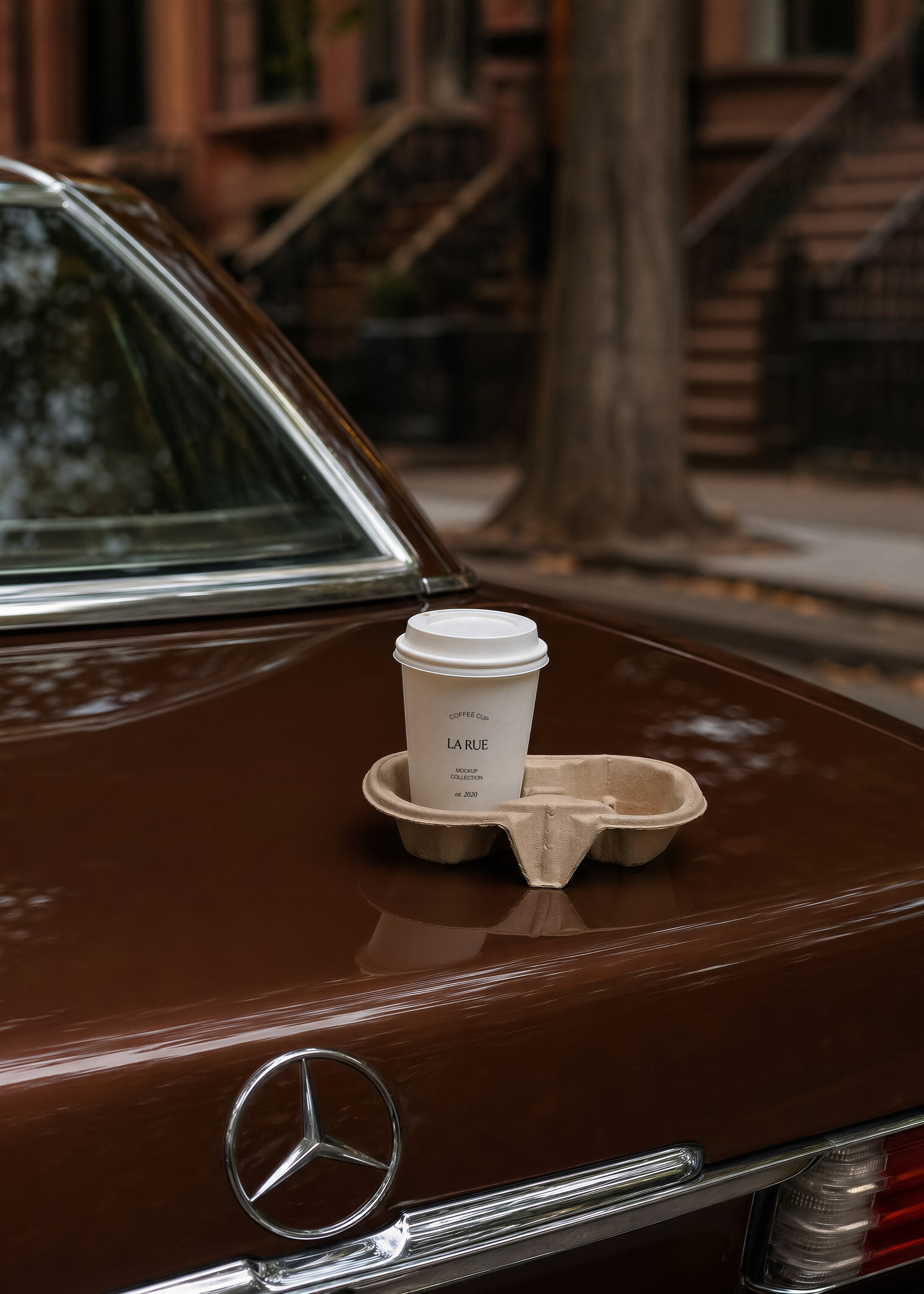 White coffee cup mockup with lid in pulp carry tray on glossy brown vintage car boot, brownstone street behind