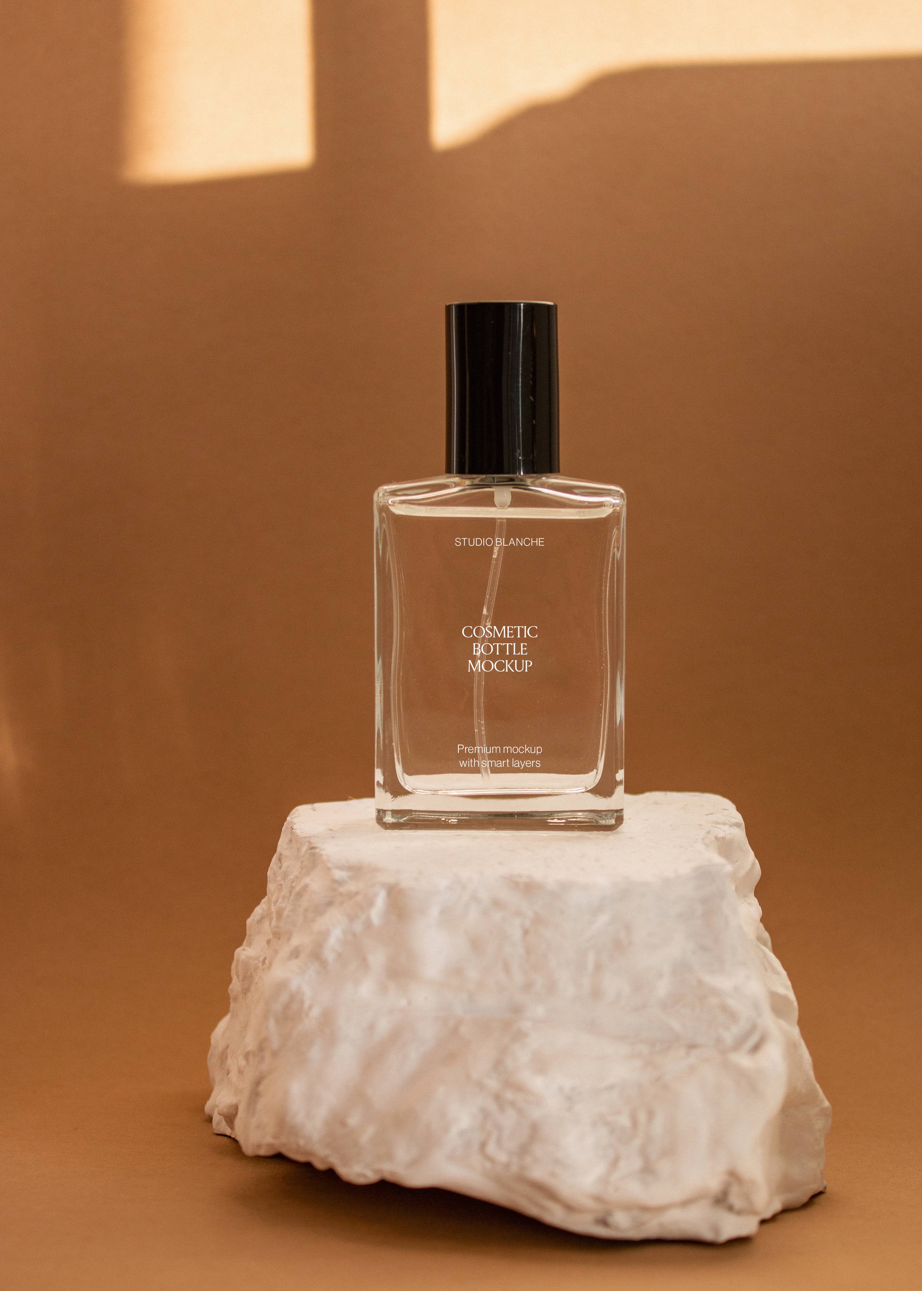 Clear glass cosmetic bottle mockup with black cap on a rough stone pedestal, warm wall with soft window light