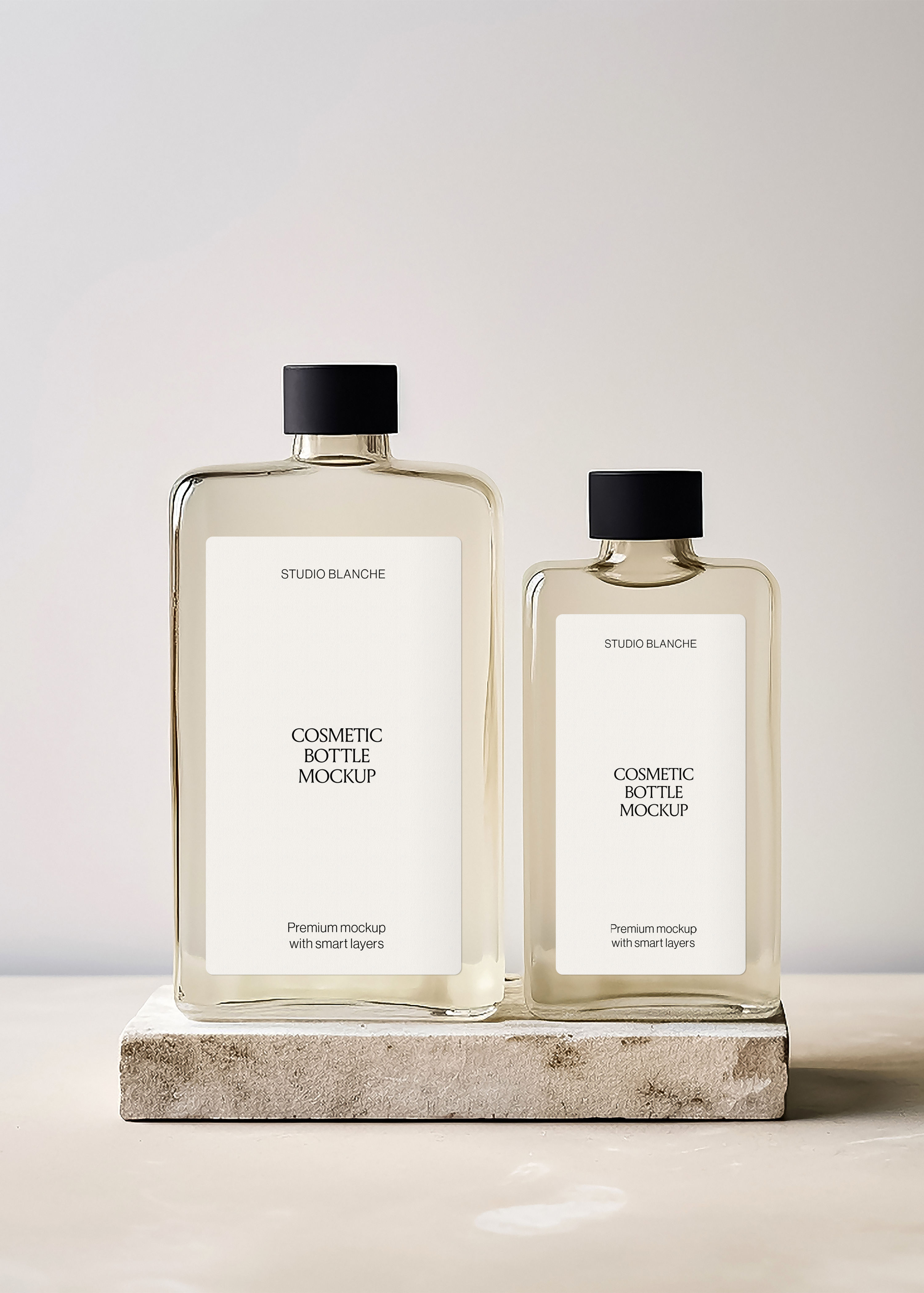 Cosmetic bottle duo mockup with white rectangular labels and black caps on textured stone, minimal editorial styling