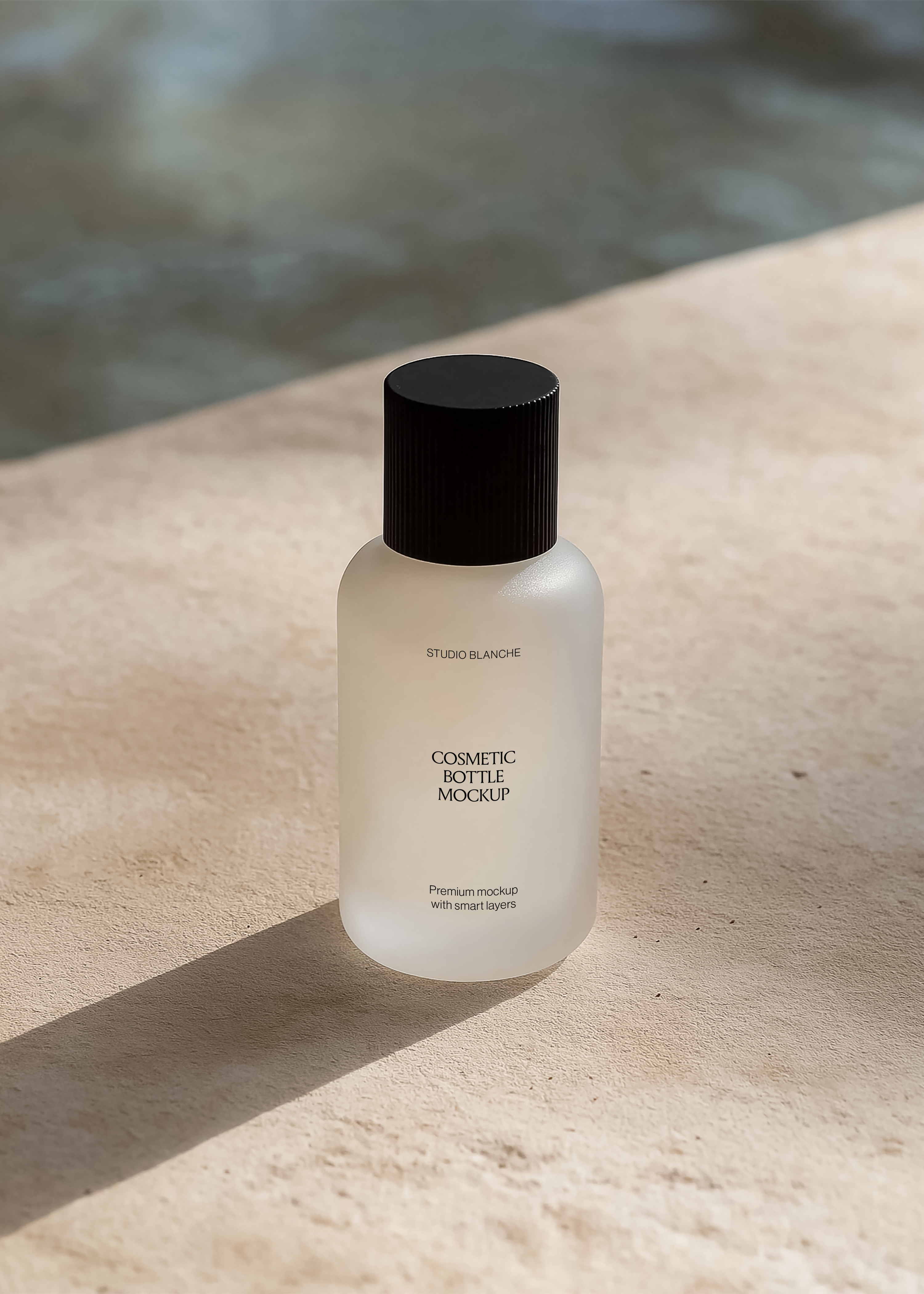 Frosted cosmetic bottle mockup with serif label and fluted black cap on sunlit stone, coastal poolside scene