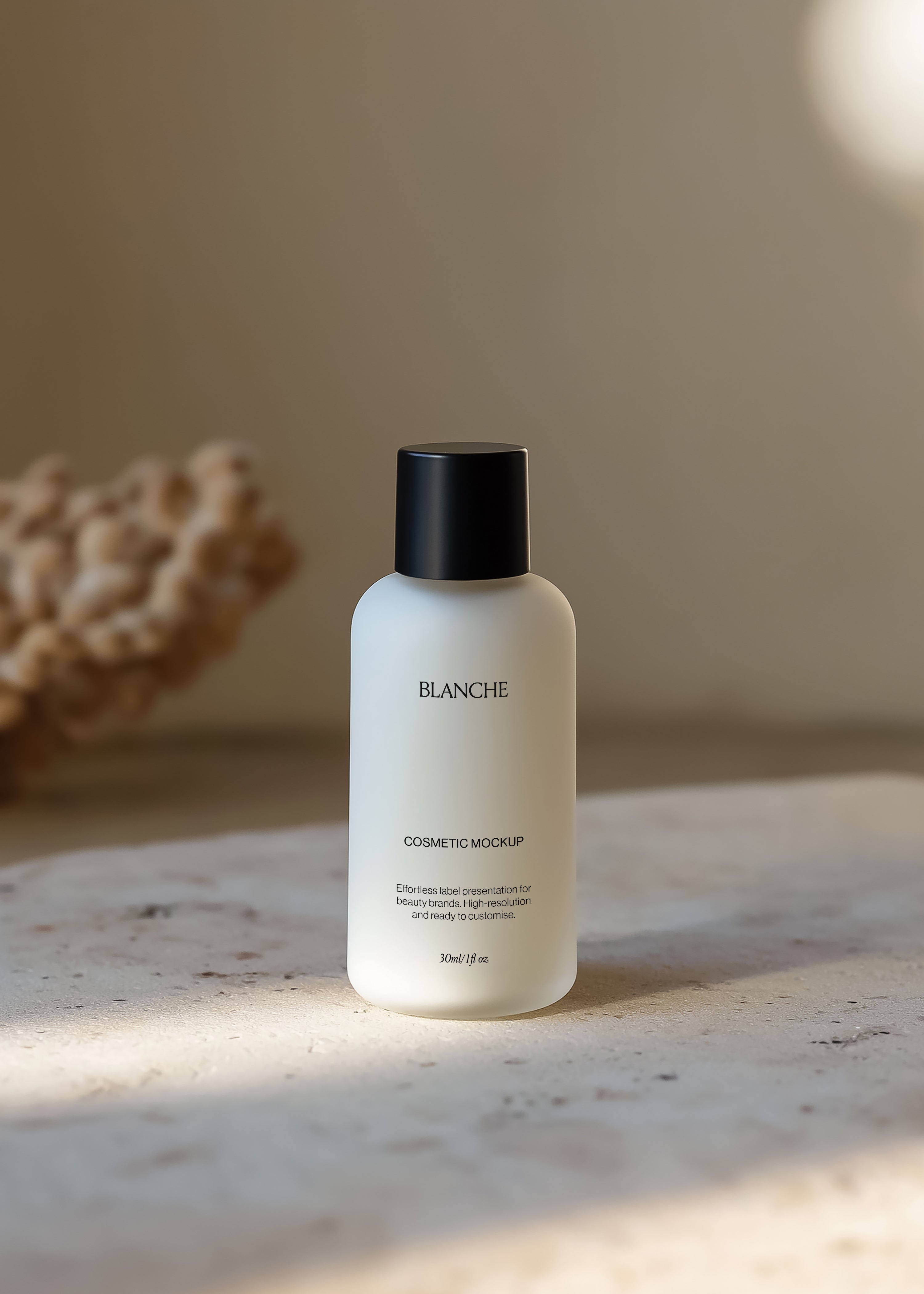 Frosted cosmetic bottle mockup with matte black cap on speckled terrazzo in soft warm interior light