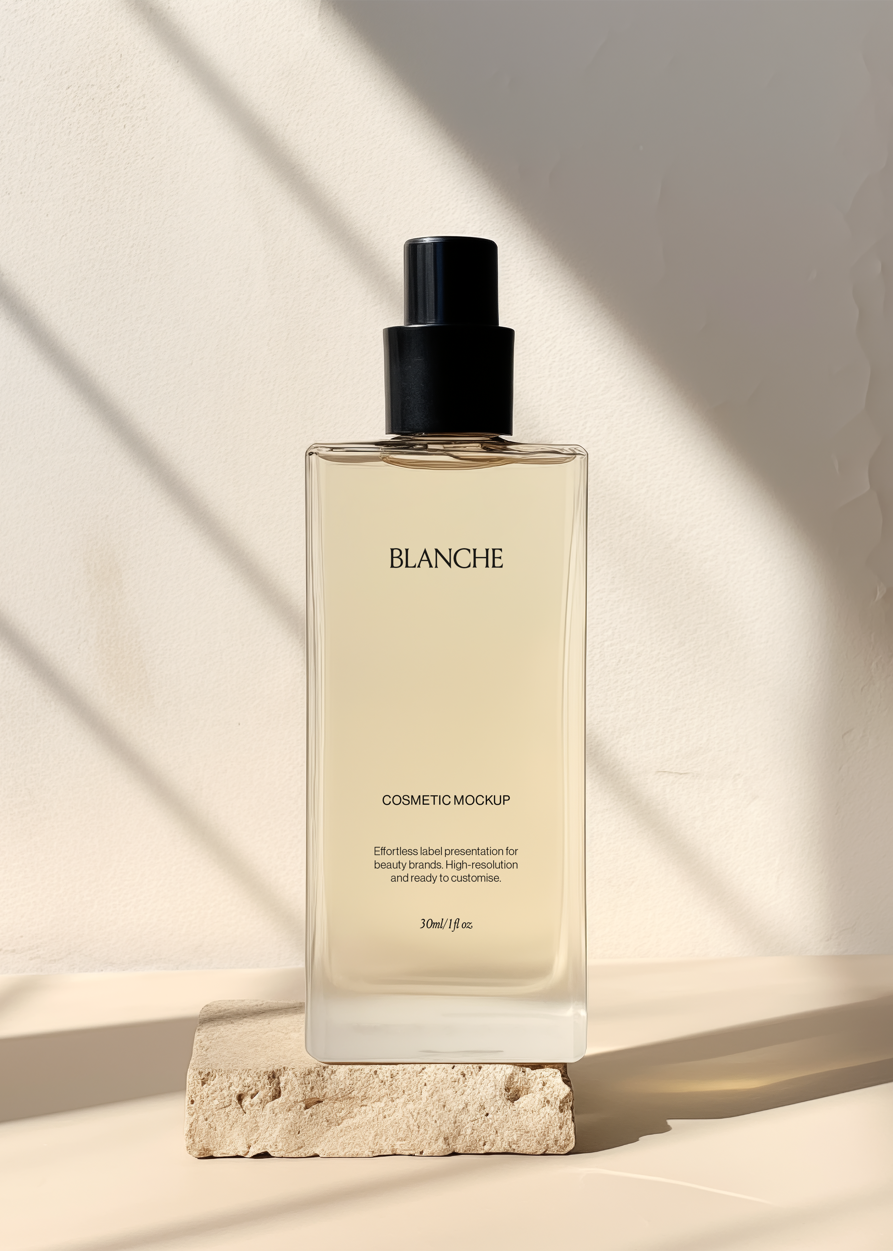 Tall clear glass cosmetic spray bottle mockup with black atomiser on a raw stone block, warm streaked light