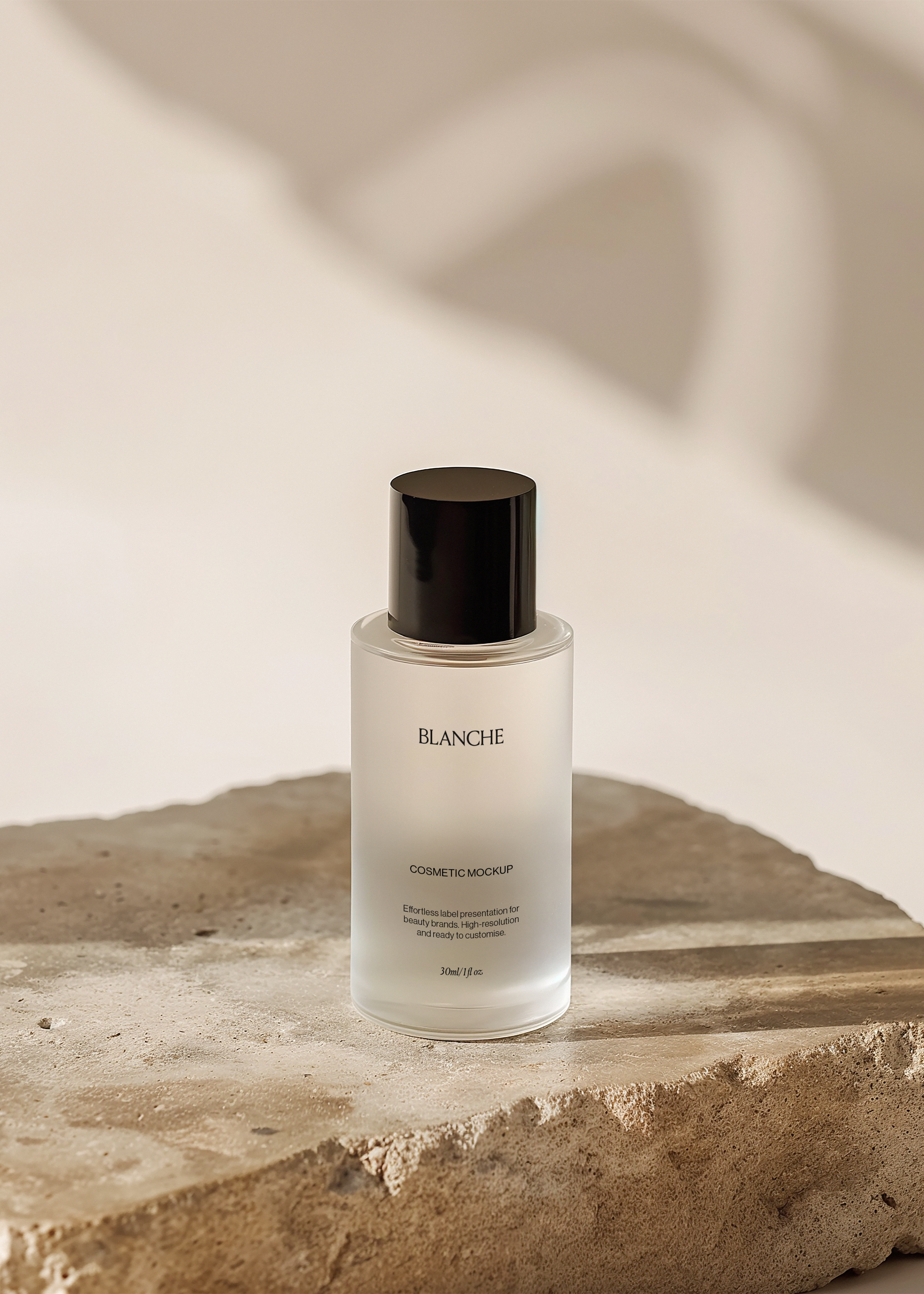 Frosted glass cosmetic bottle mockup with tall glossy black cap on a round stone slab, warm blurred shadow