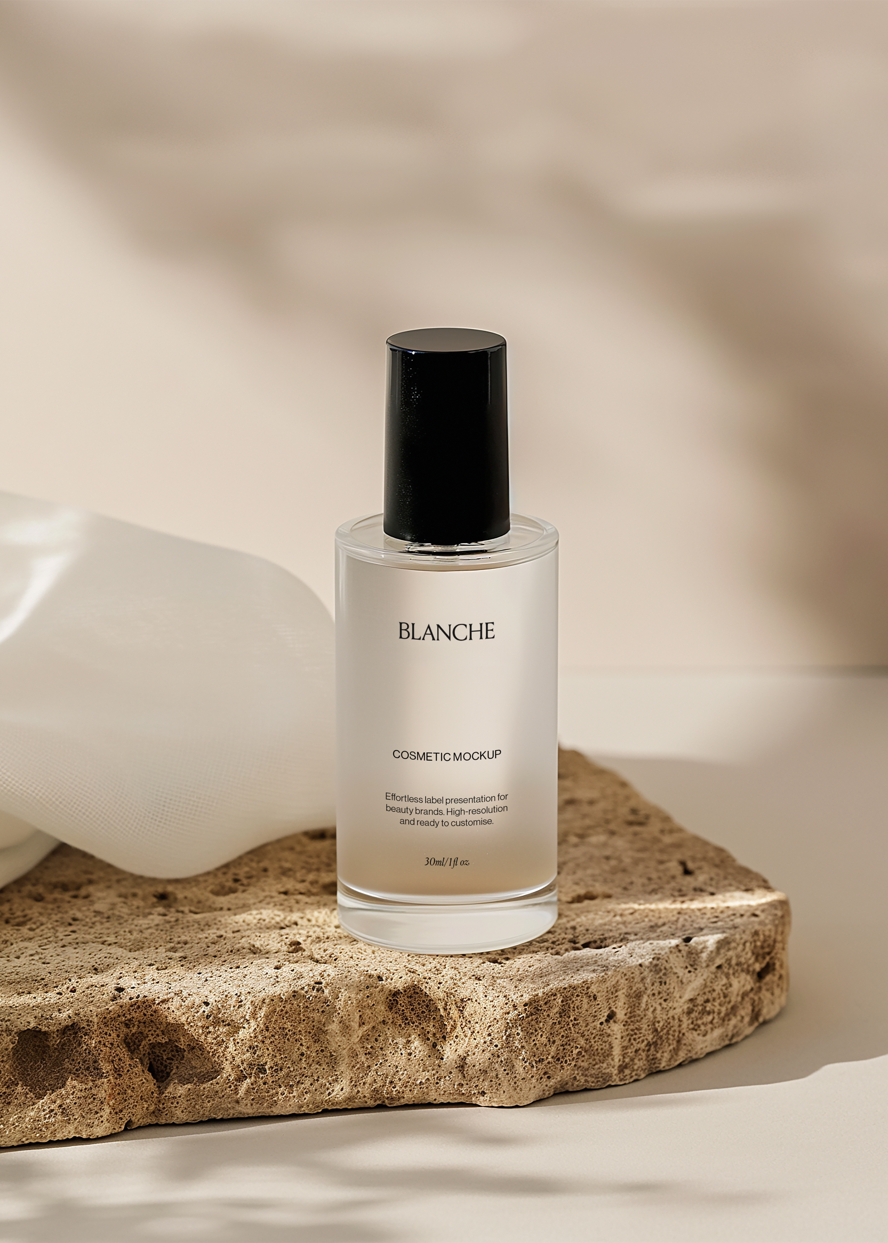 Frosted glass cosmetic bottle mockup with black cap on a porous travertine slab beside white fabric, warm neutral scene