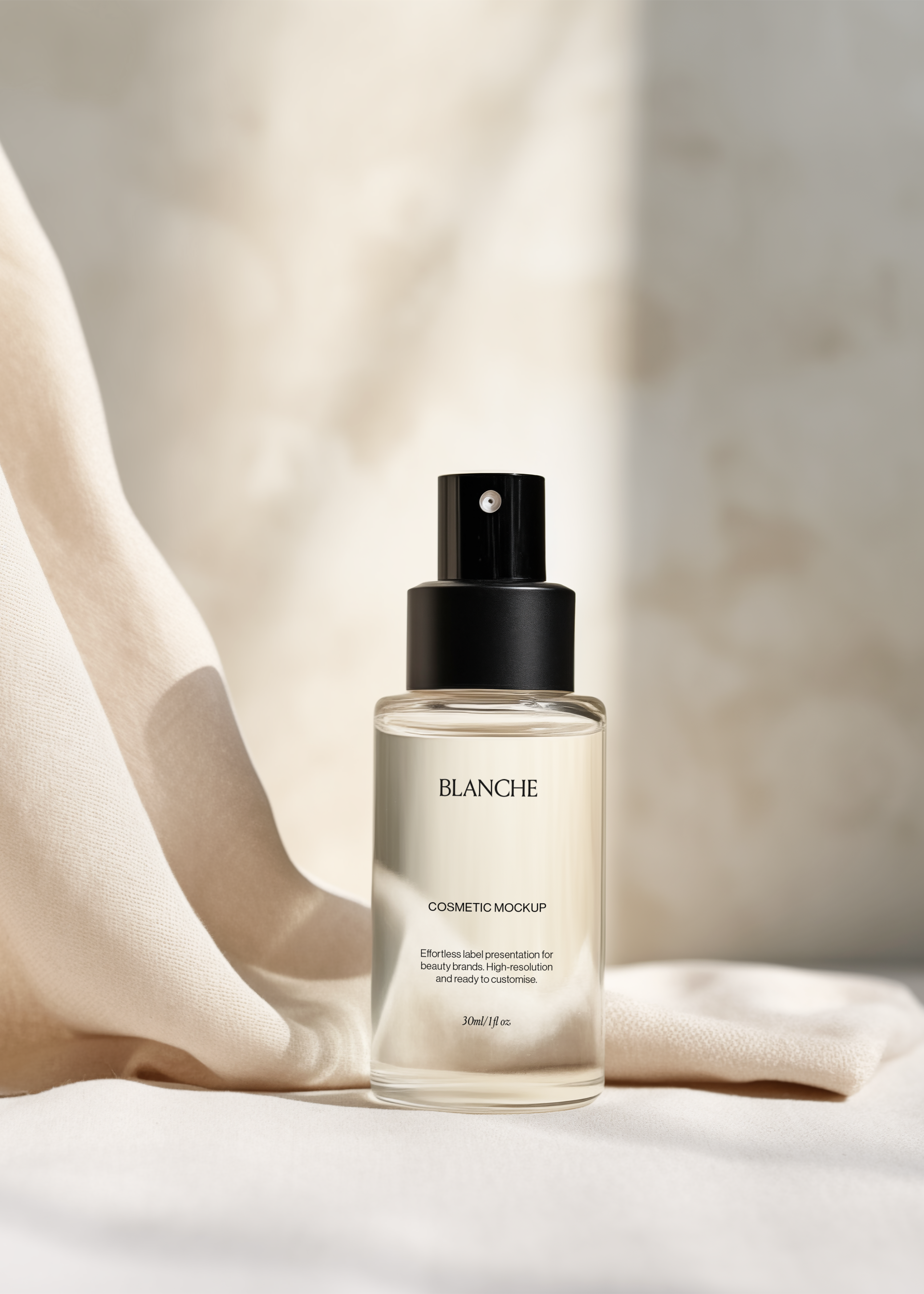 Clear glass cosmetic spray bottle mockup with black atomiser on cream linen with draped fabric, soft diffused light