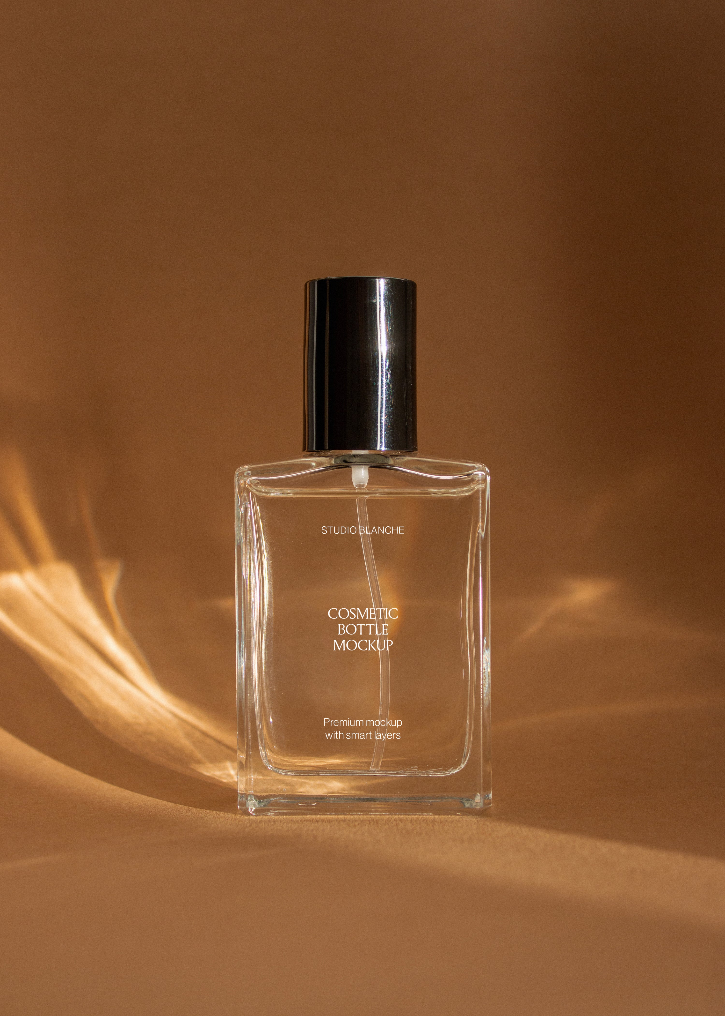 Clear glass cosmetic bottle mockup with black spray cap and white label, warm backlit glow and fanned shadow