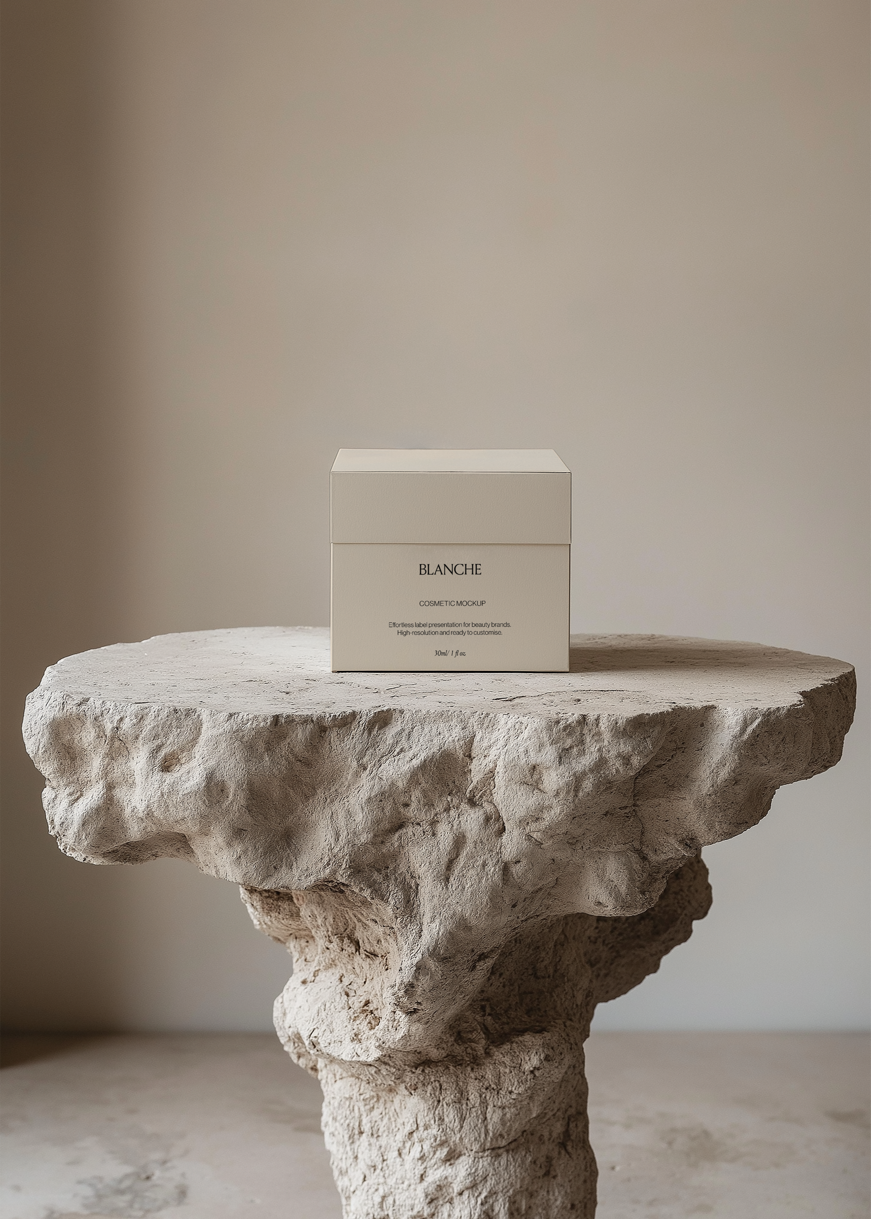 Square cream cosmetic box mockup on a rough sculptural stone plinth against a soft neutral wall in minimal styling
