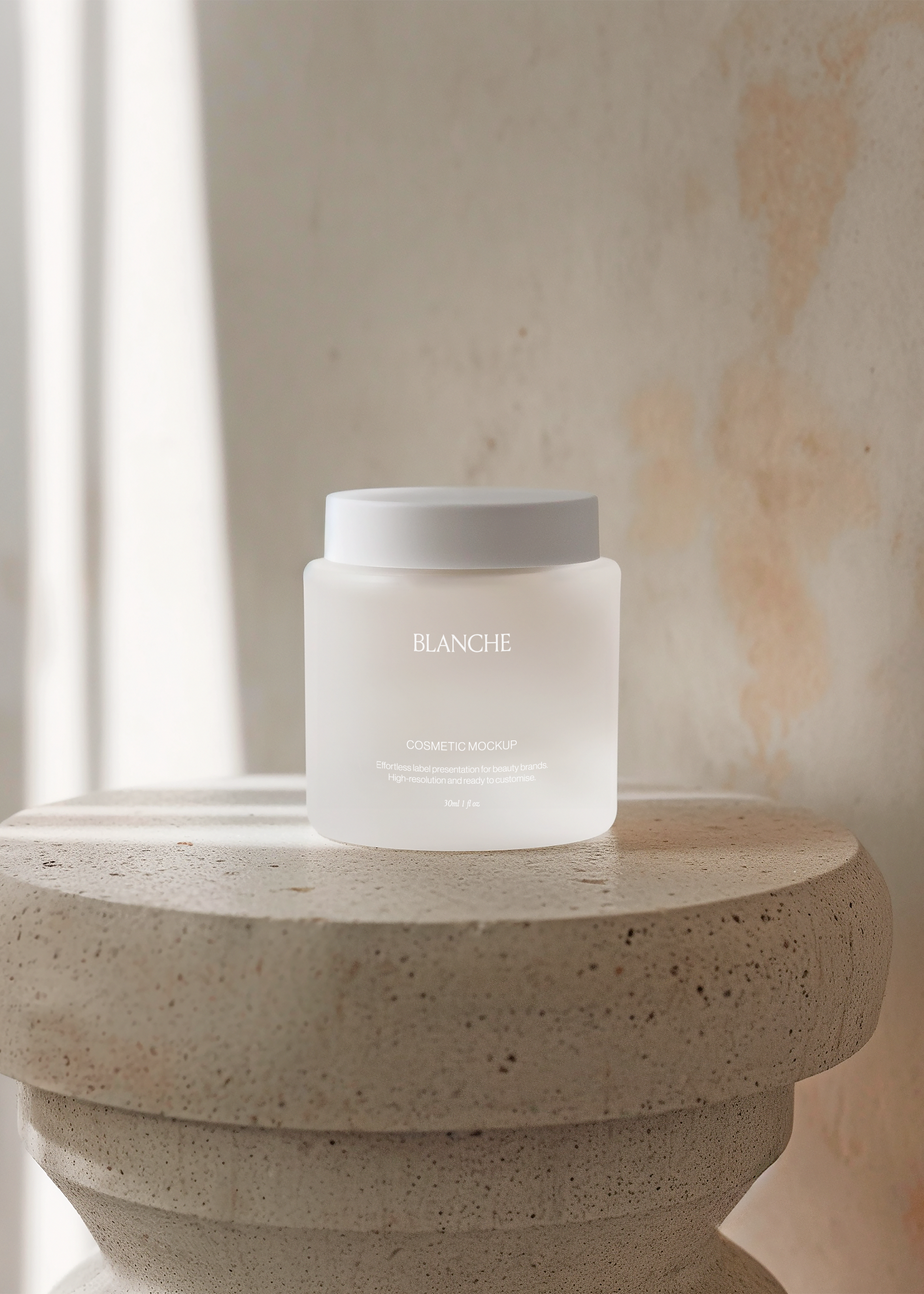 Frosted white cosmetic jar mockup with matching lid on rounded travertine plinth against warm plaster wall