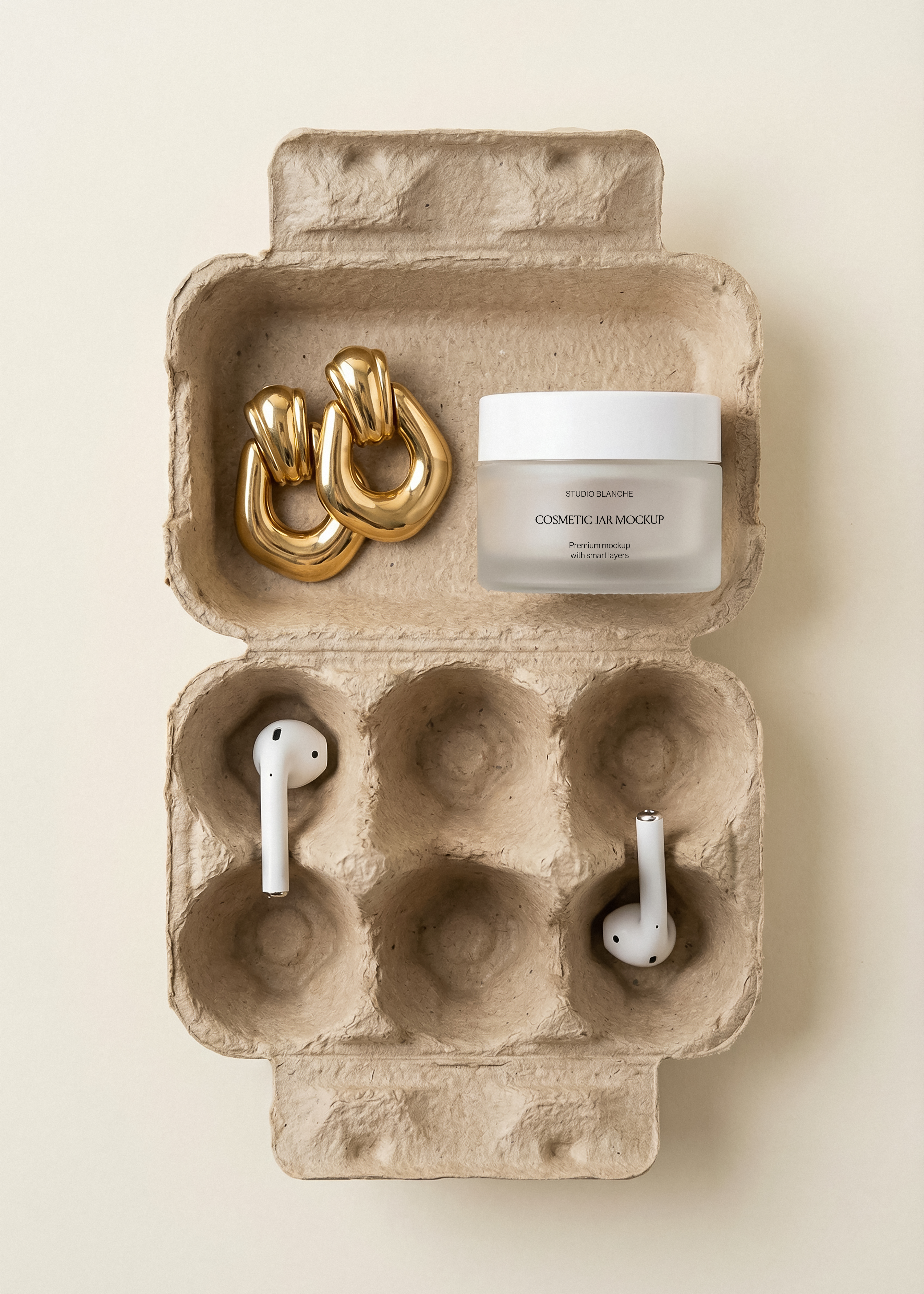 Frosted cosmetic jar mockup and chunky gold earrings in carton lid, white earbuds in egg wells below