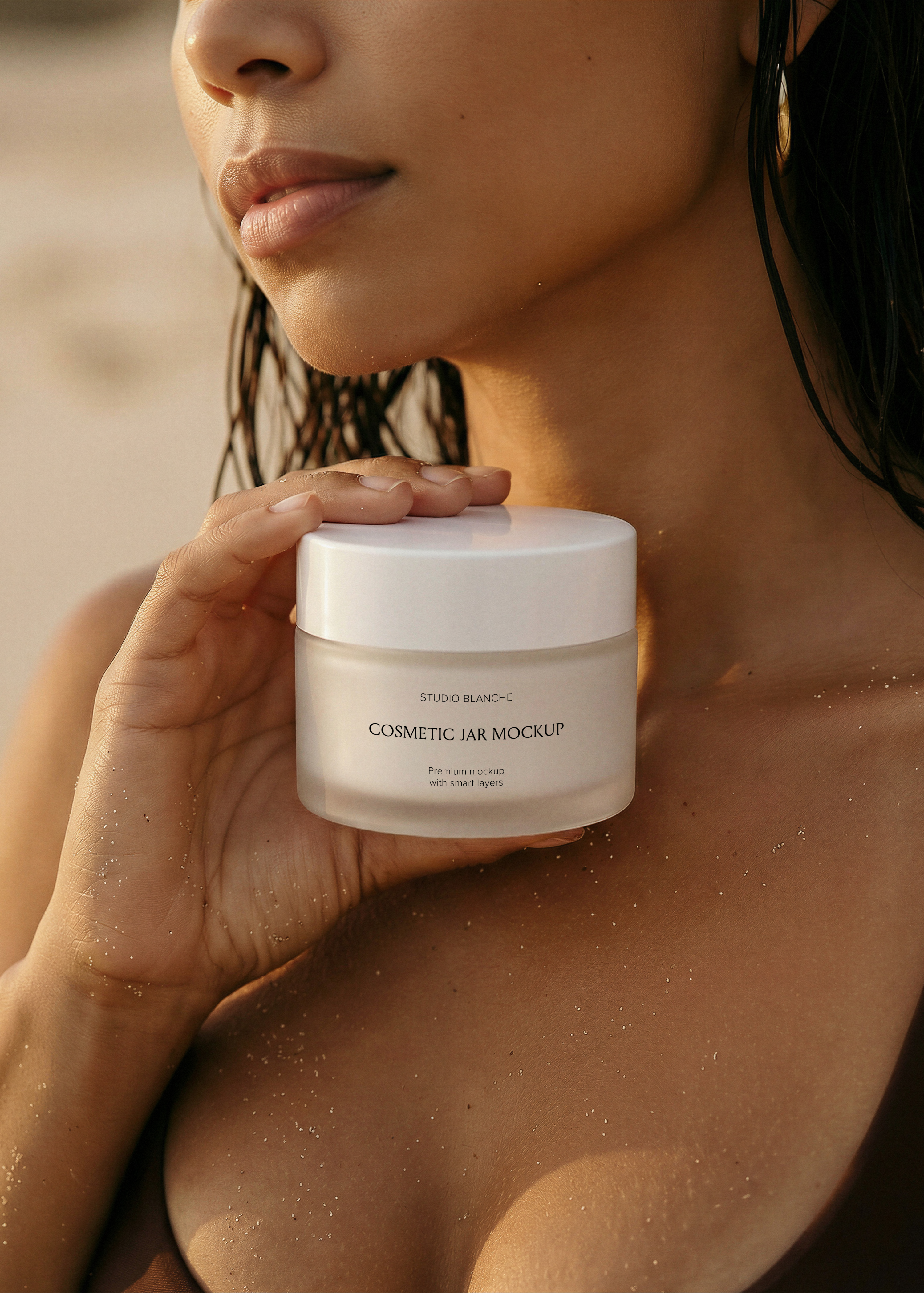 Frosted cosmetic jar mockup close-up on bare shoulder, wet hair, gold hoop earring, warm editorial coastal styling