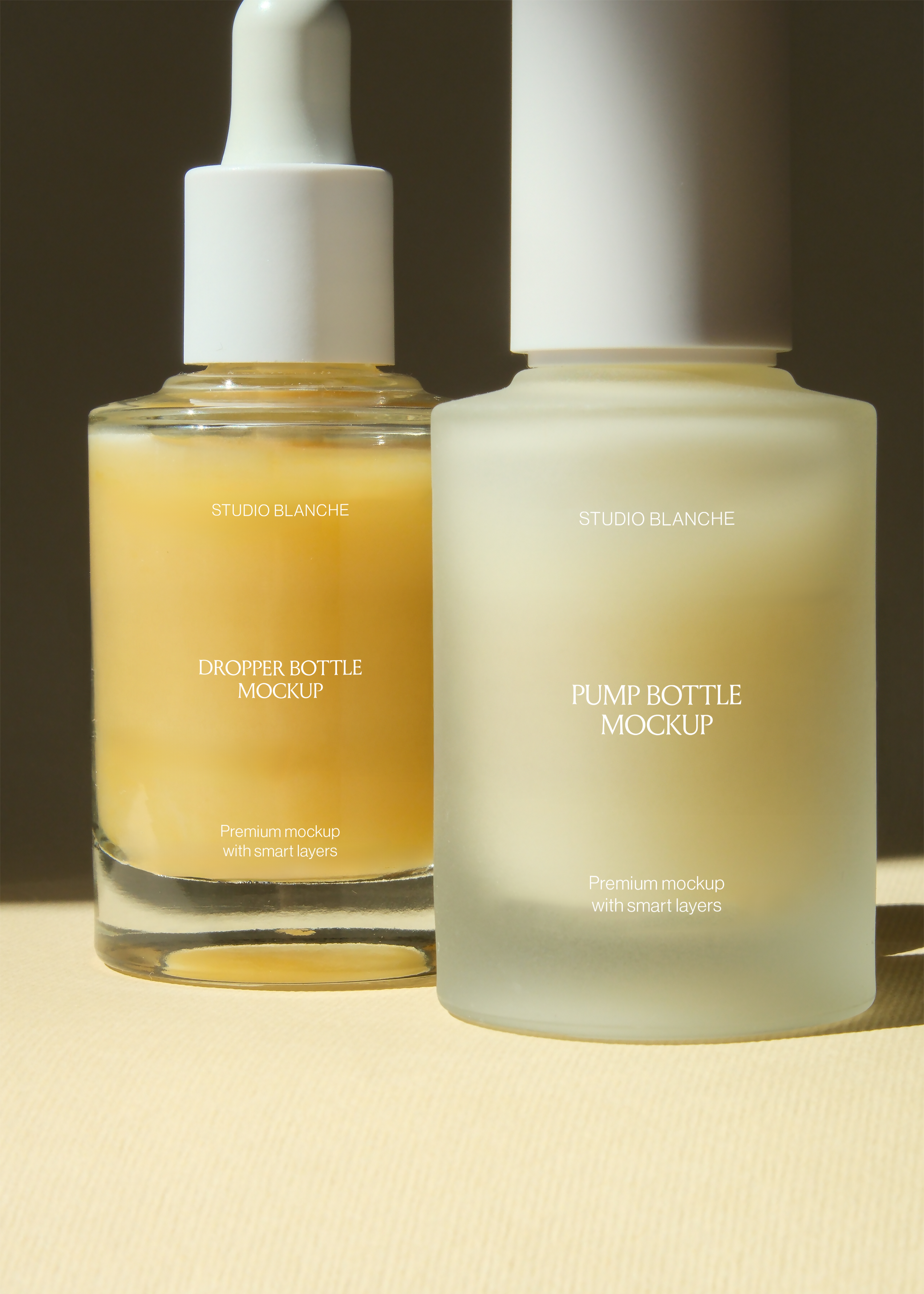 Close crop of dropper and pump bottle mockup pair with Studio Blanche label, direct light catching amber glass