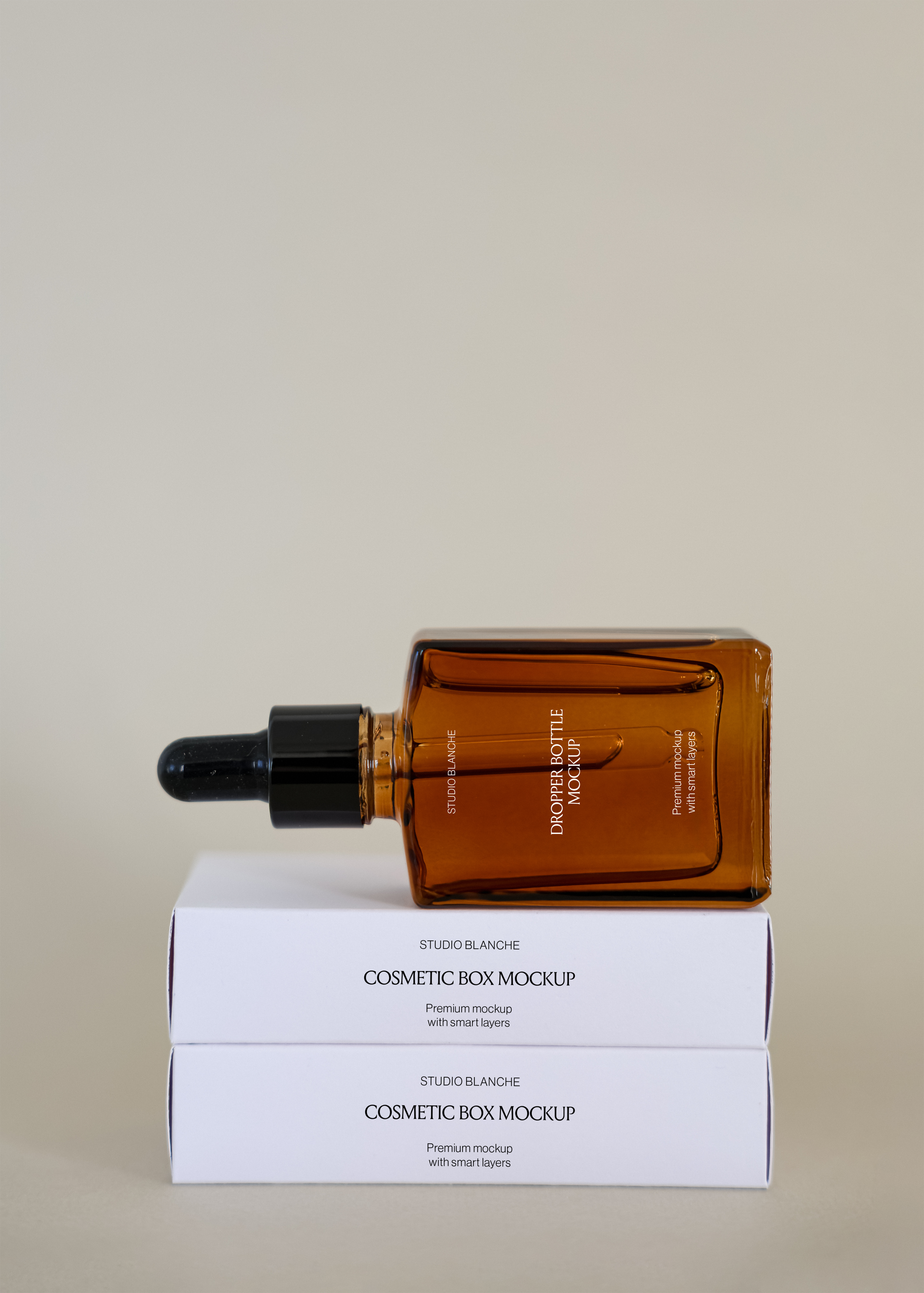 Amber dropper bottle with black cap resting on two stacked cream cosmetic boxes, minimal warm studio scene