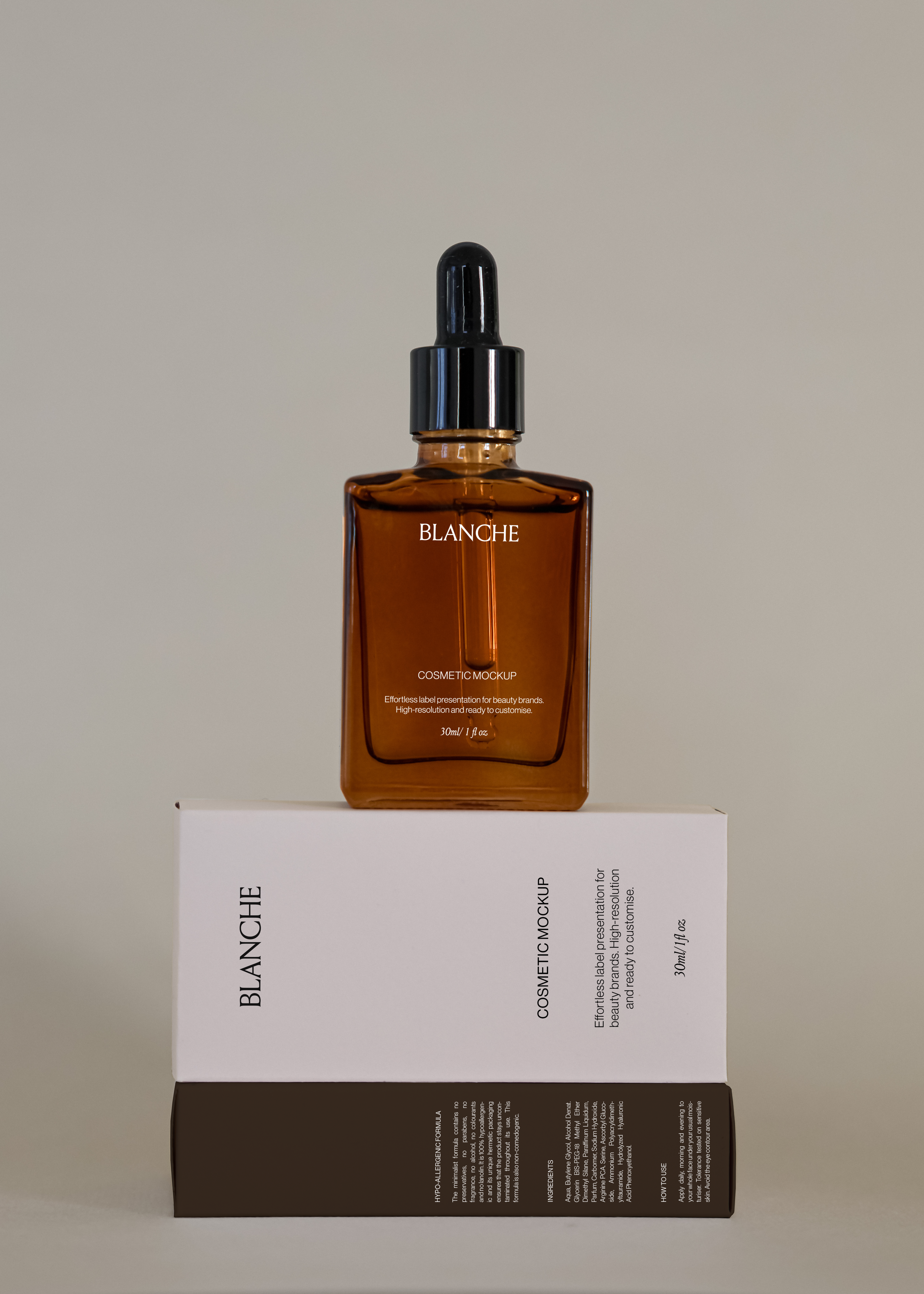 Amber glass dropper bottle mockup standing on white cosmetic box with dark base against neutral studio backdrop