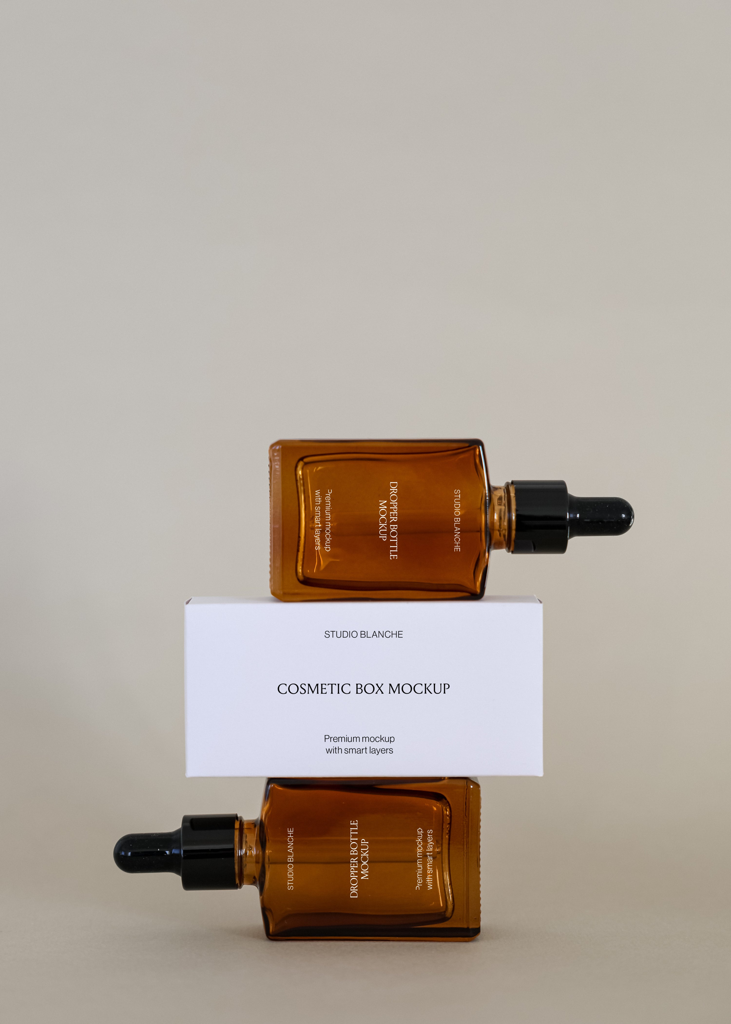 Two horizontal amber dropper bottles with black caps balanced around a white cosmetic box, minimal studio scene