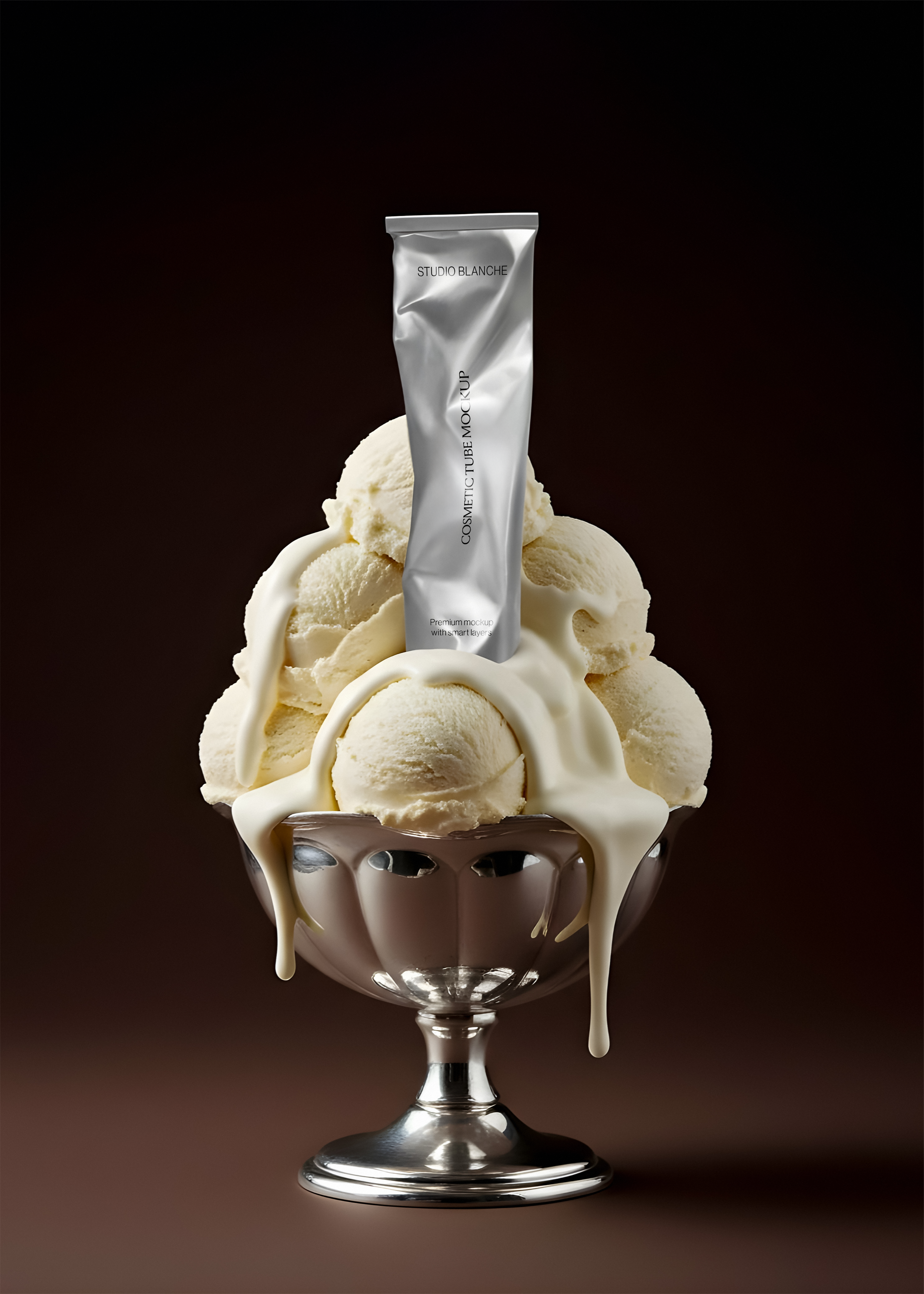 Metallic cosmetic tube mockup standing in a silver footed sundae bowl, cream running down the stem, dark backdrop