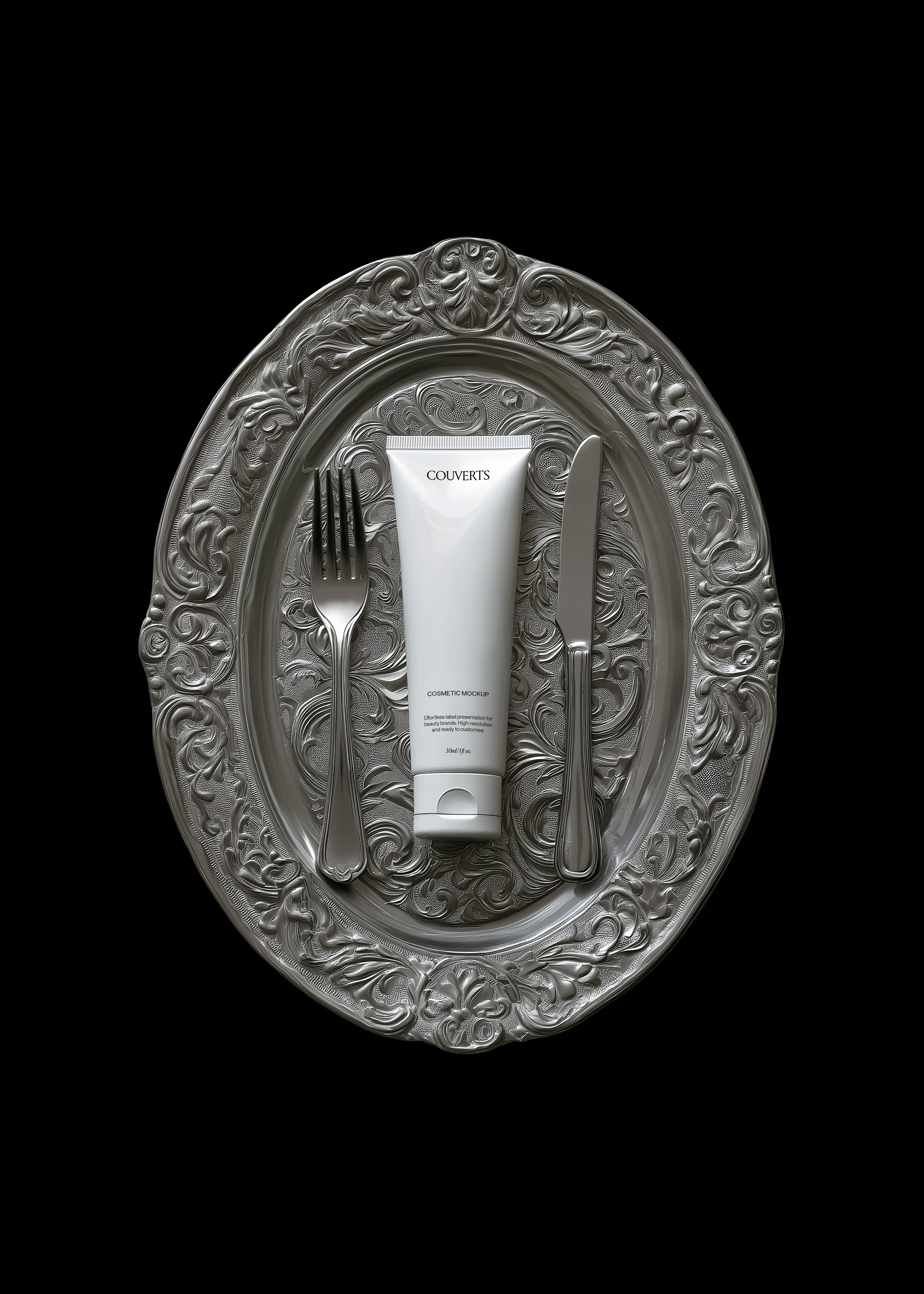 Cosmetic tube mockup on ornate silver dinner plate with fork and knife, black background, monochrome editorial styling