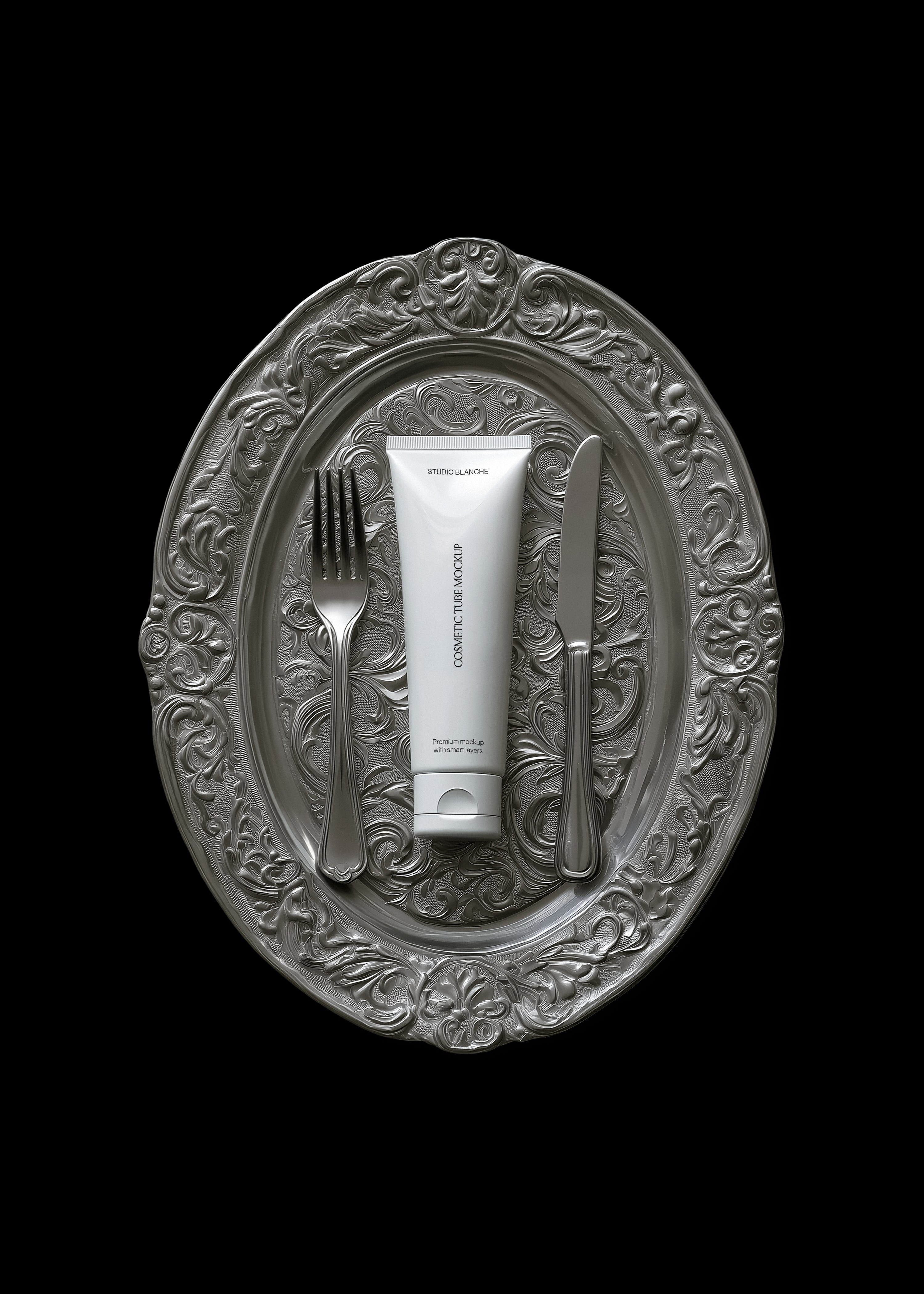 White cosmetic tube mockup upright on engraved silver platter beside silver cutlery, dark background, top-down view