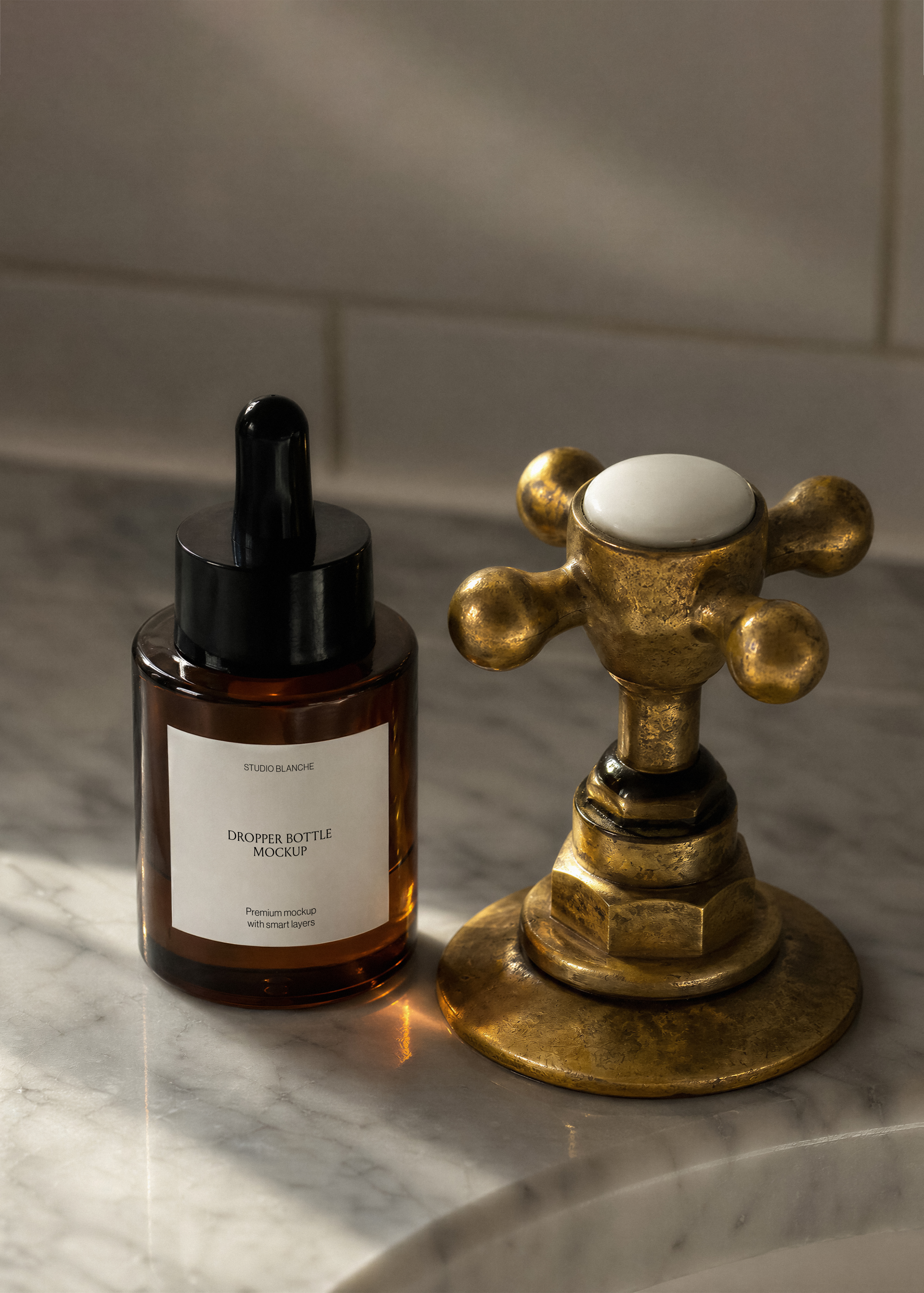 Serum dropper bottle mockup on marble counter next to brass cross tap, strong warm sunlight and shadow, editorial scene