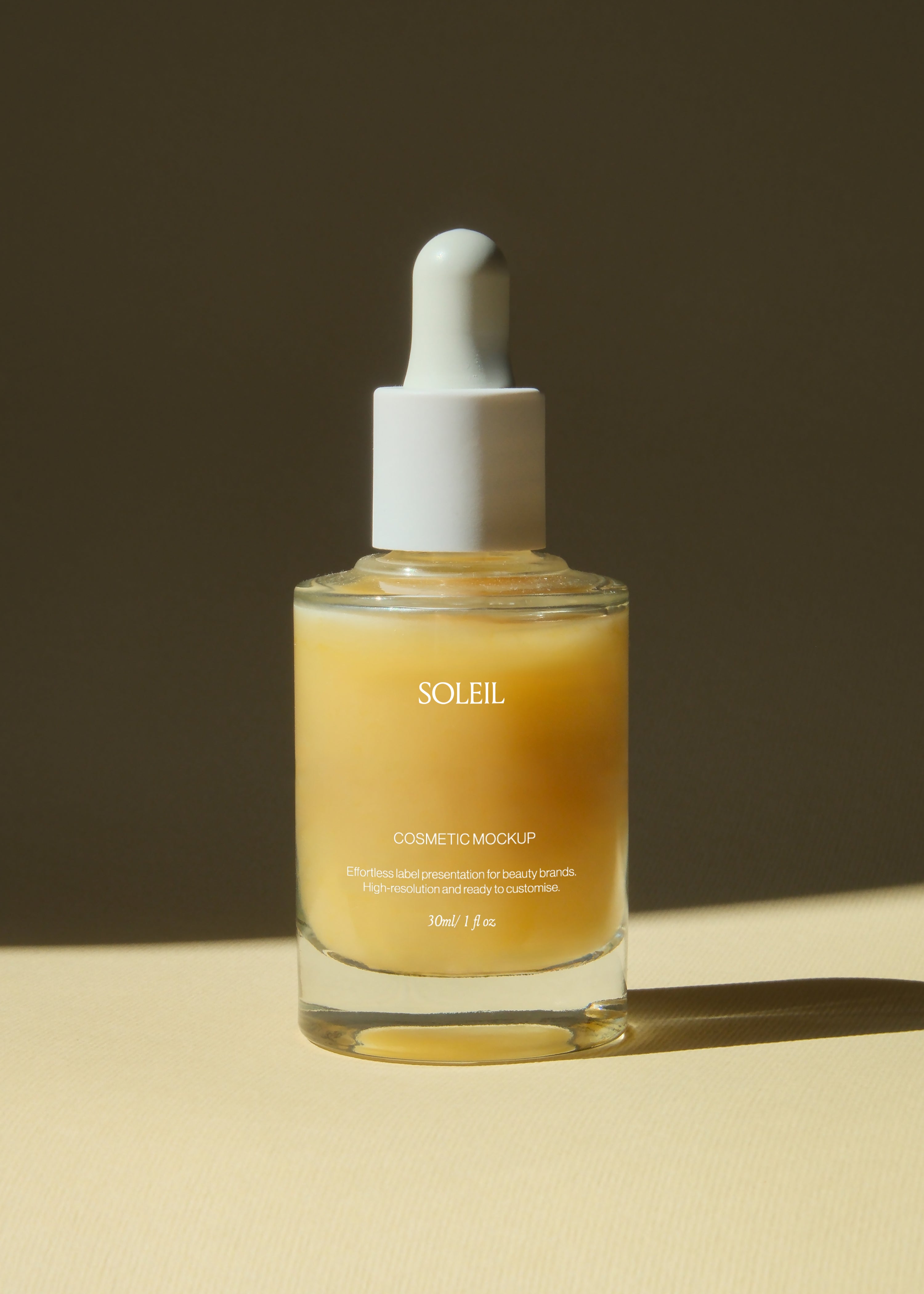 Glass dropper bottle mockup with amber liquid and white pipette cap, dark backdrop, warm sunlit side lighting