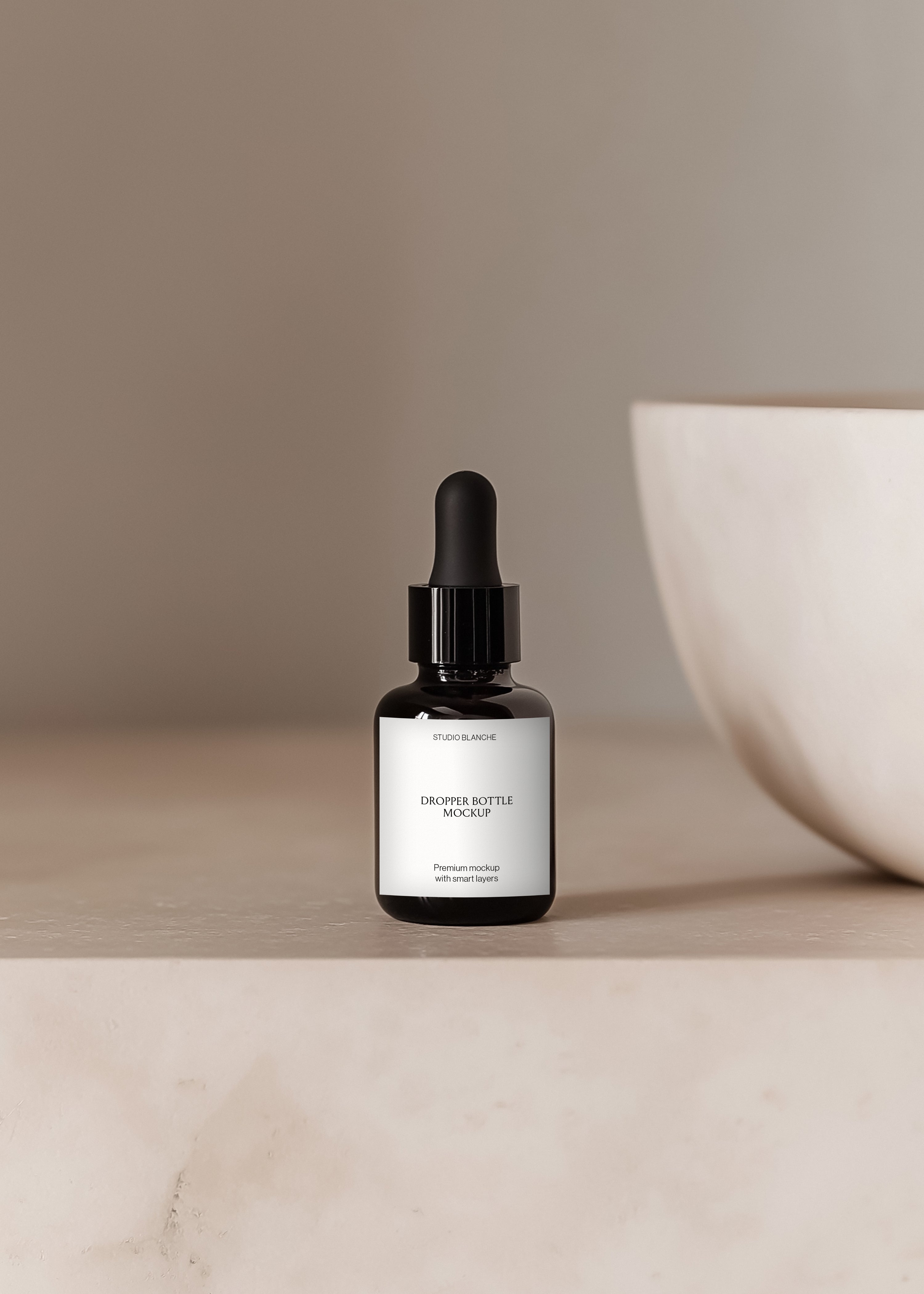 Serum dropper bottle mockup with black cap on sandstone surface, soft studio light and white bowl behind, minimal styling