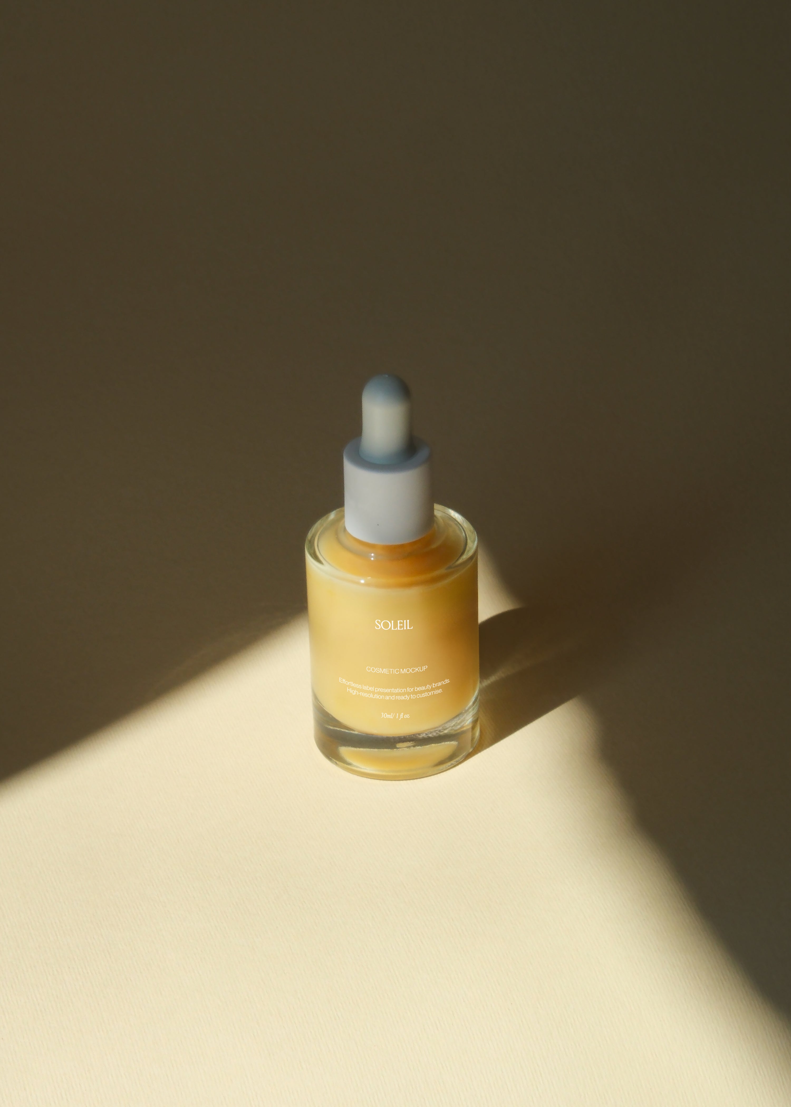 Amber glass dropper bottle on dark backdrop with diagonal sunbeam crossing the label, warm editorial lighting