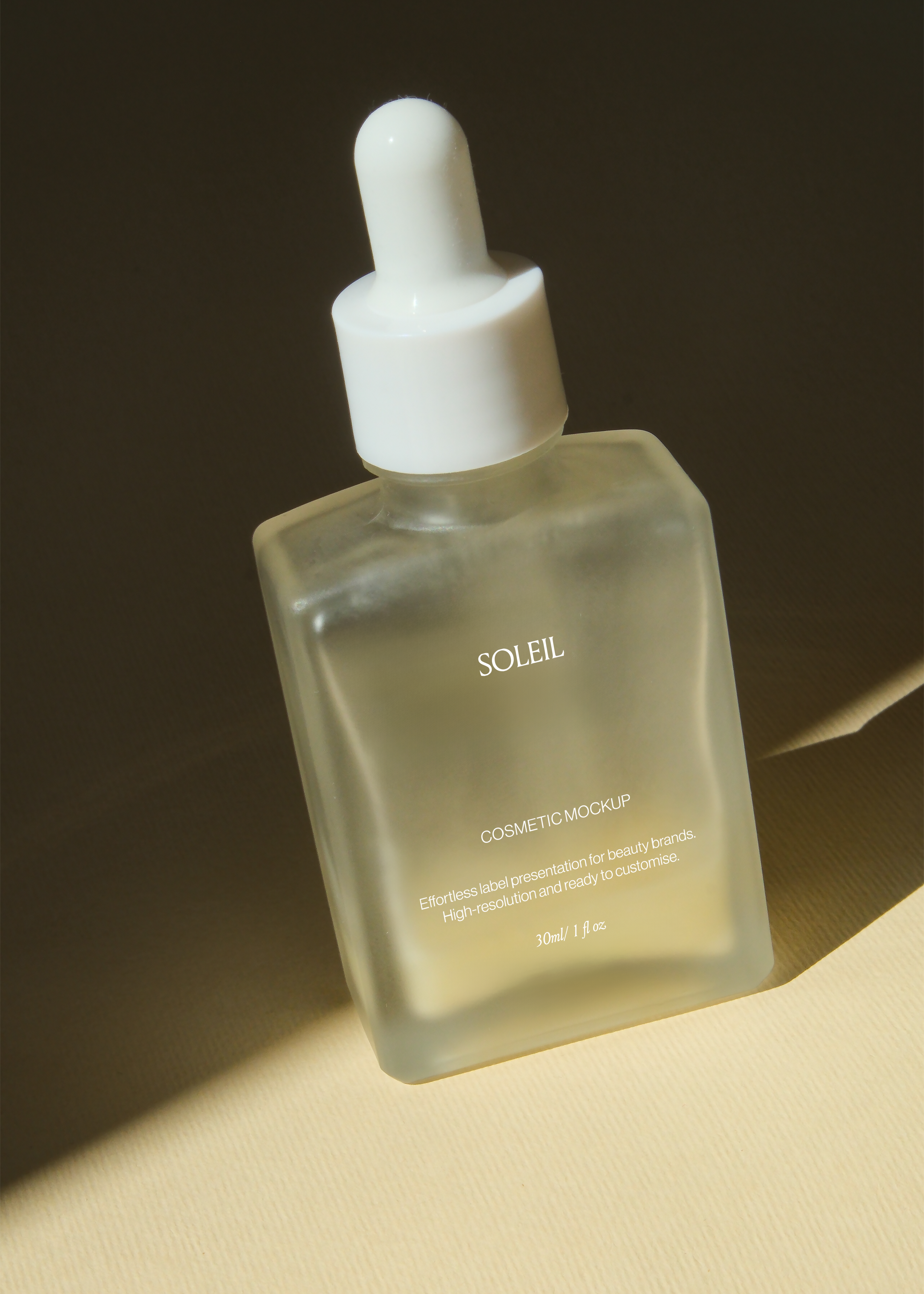Frosted glass dropper bottle angled against dark backdrop with soft warm light along one edge, matte square silhouette