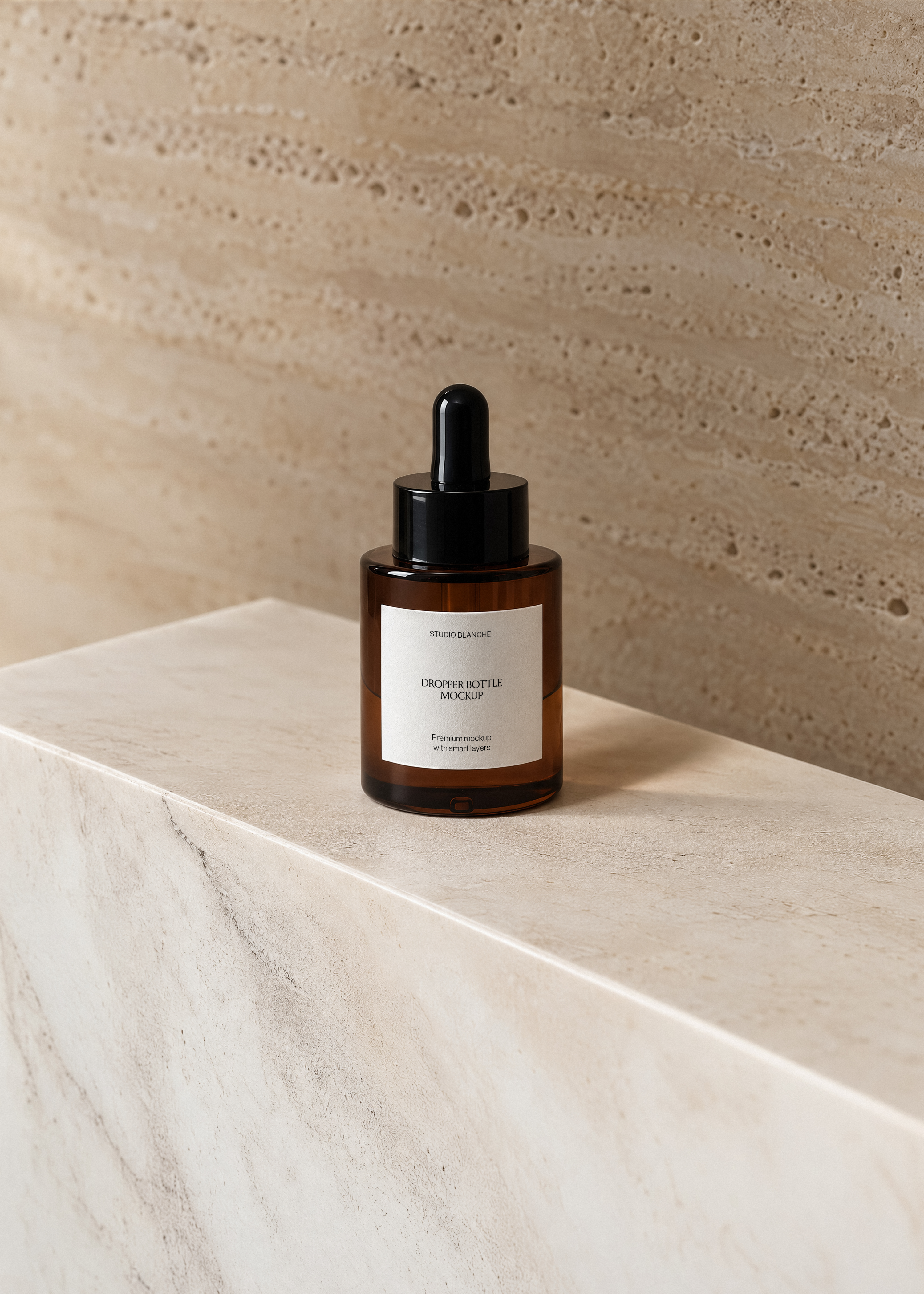 Amber glass dropper bottle mockup with black cap and white label on travertine plinth, warm textured stone wall behind