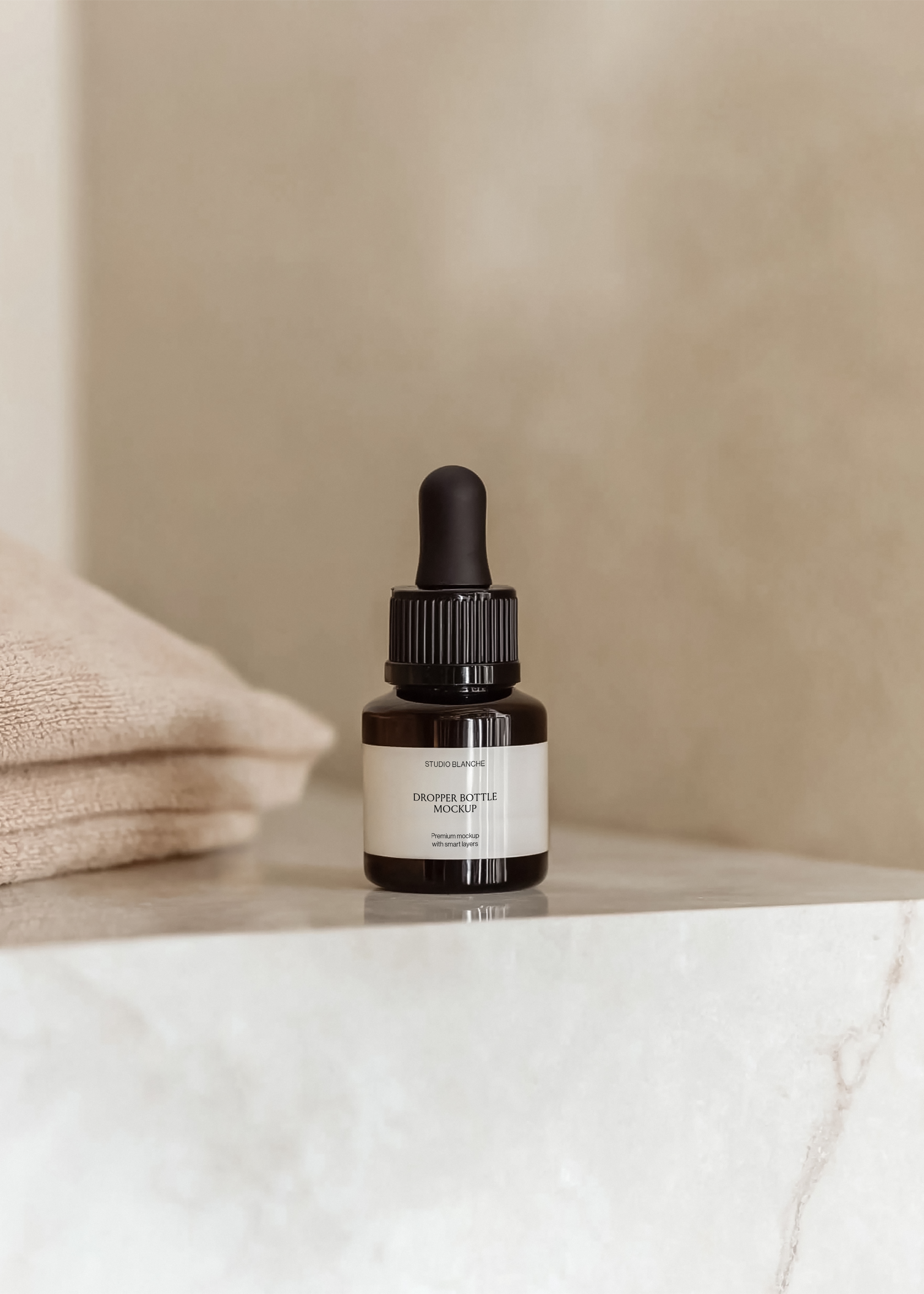 Serum dropper bottle mockup on marble surface with stacked beige towel behind, warm directional light, minimal spa styling