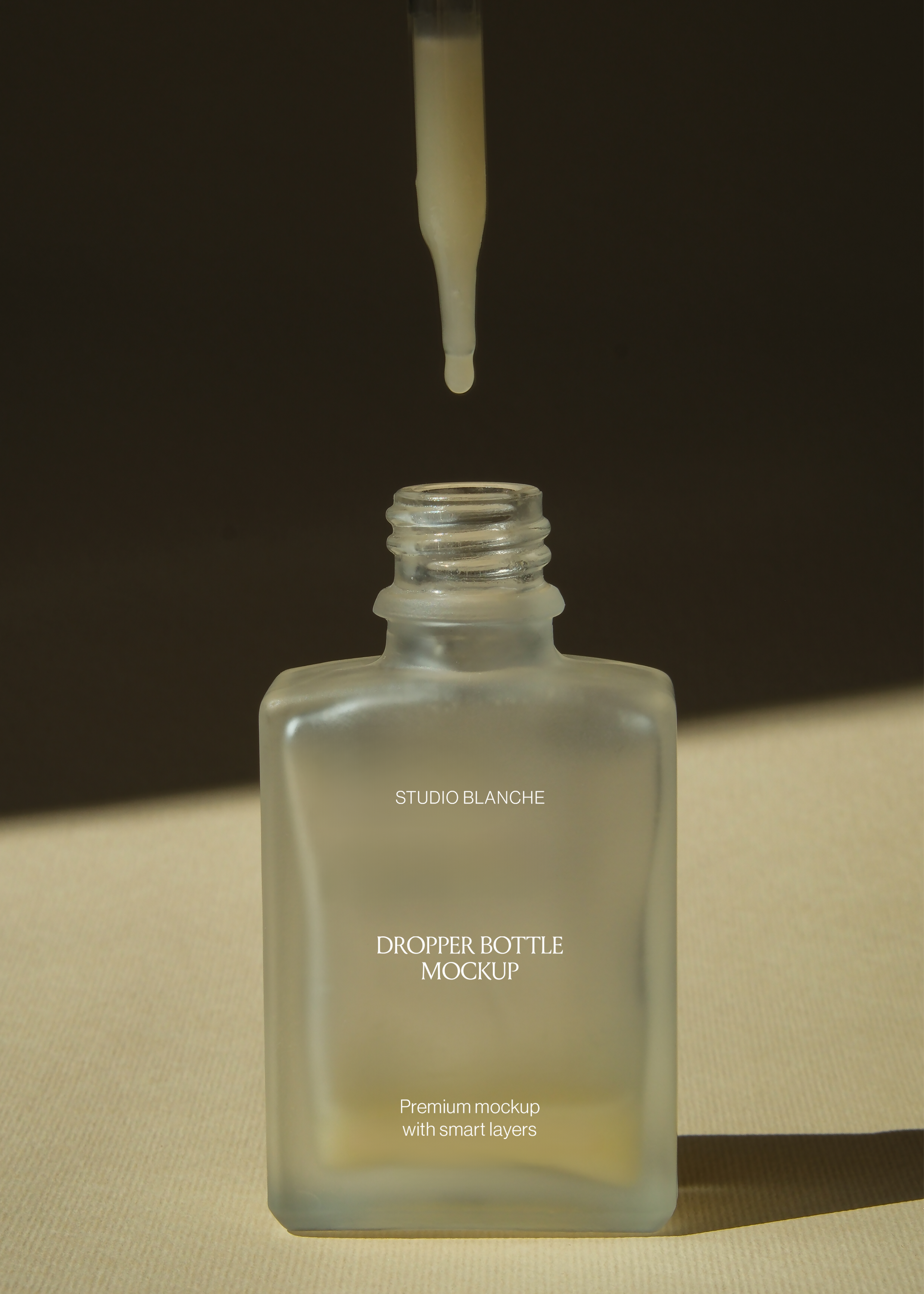 Close view of frosted rectangular dropper bottle threaded opening with pipette raised, dark wall behind