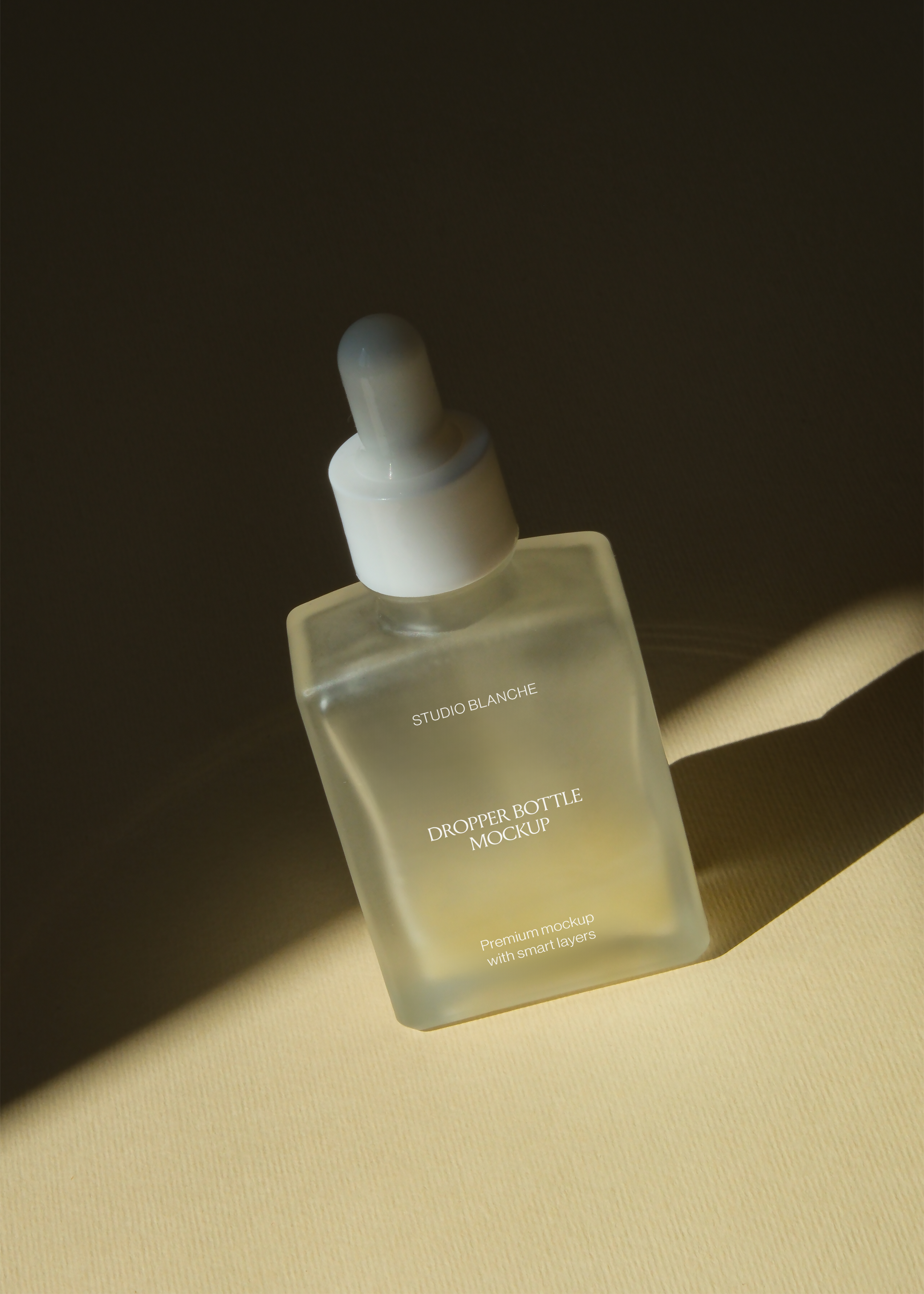Angled view of frosted rectangular dropper bottle with white pipette cap, dark wall, warm diagonal lighting
