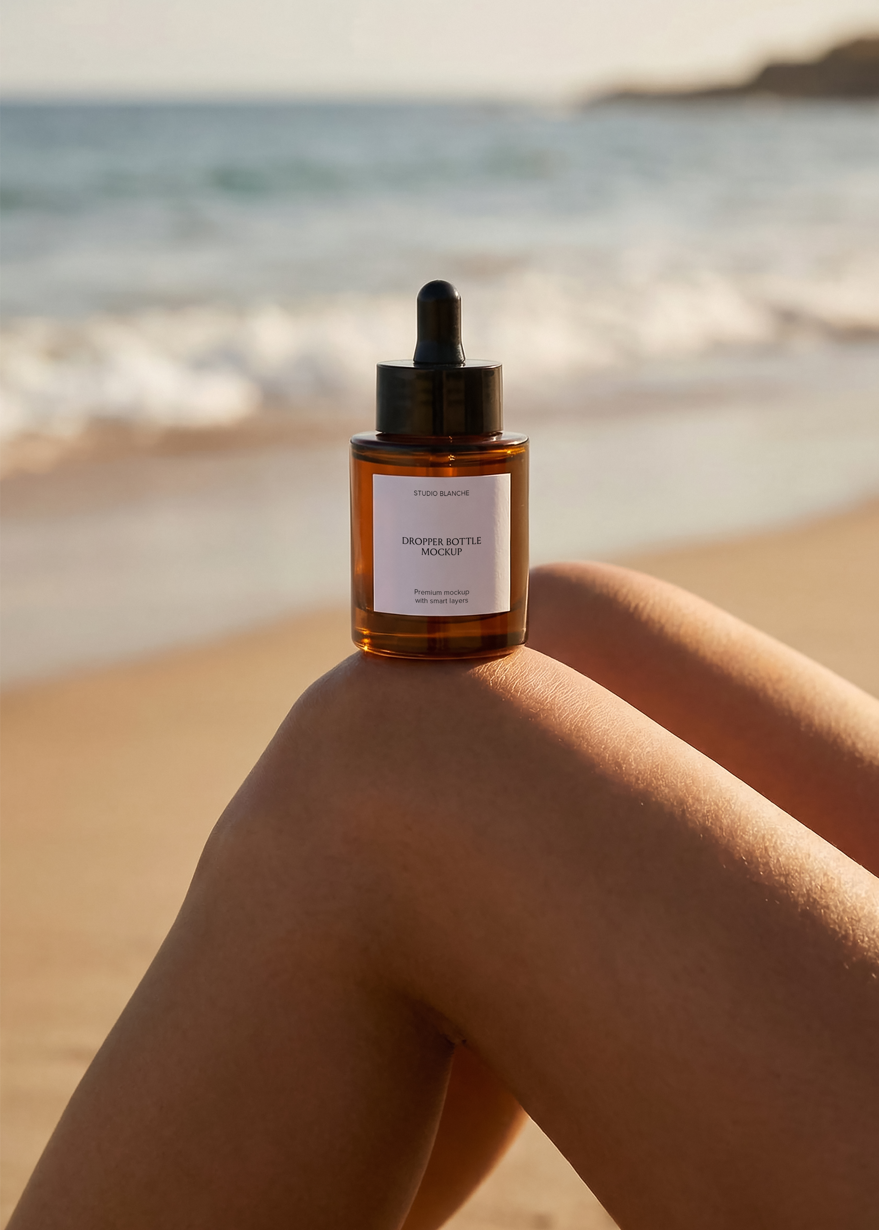Amber glass serum dropper bottle mockup on bare knee at the beach, black pipette top, backlit waves, editorial styling