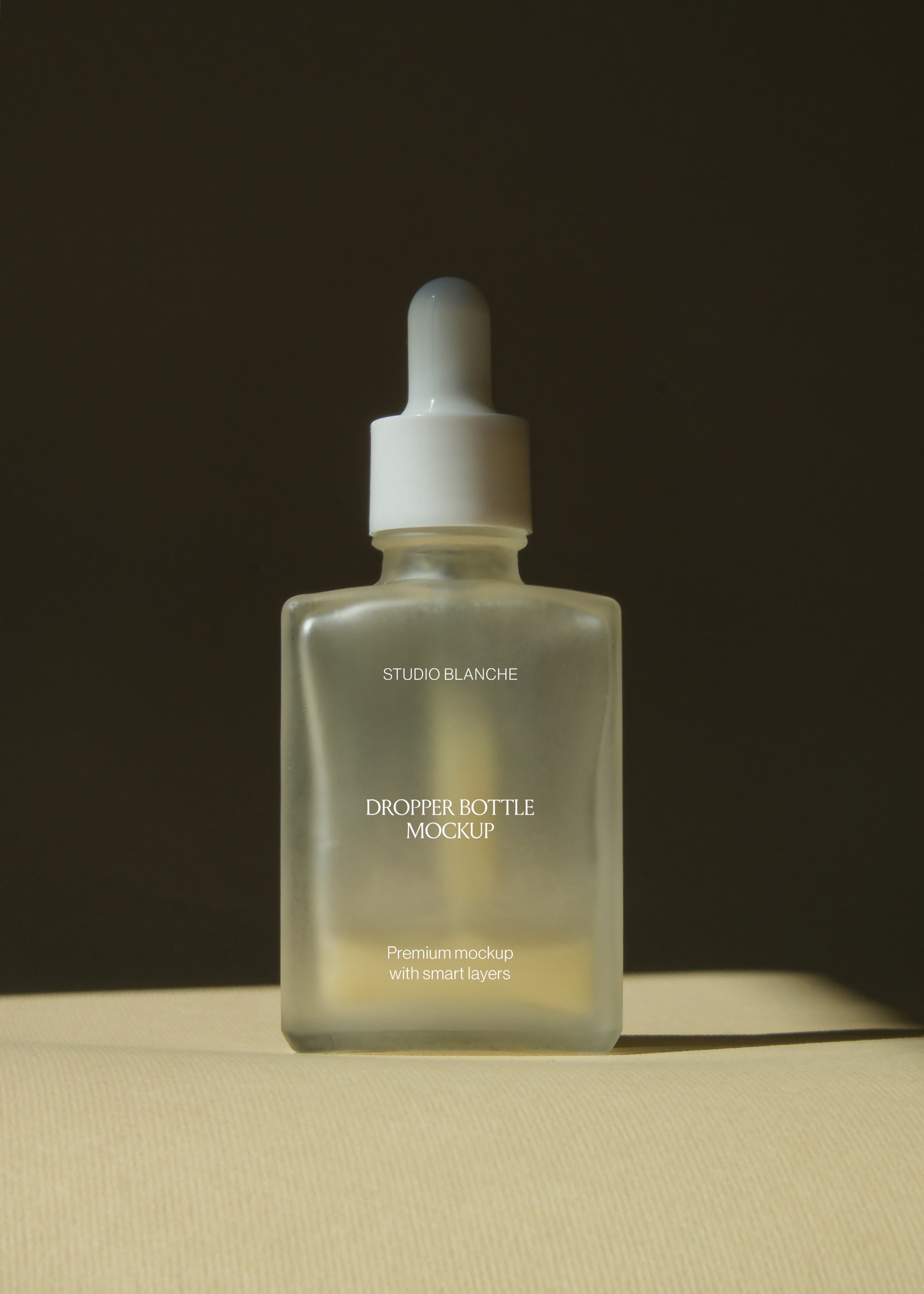 Straight-on view of frosted rectangular dropper bottle with white pipette cap, dark wall behind