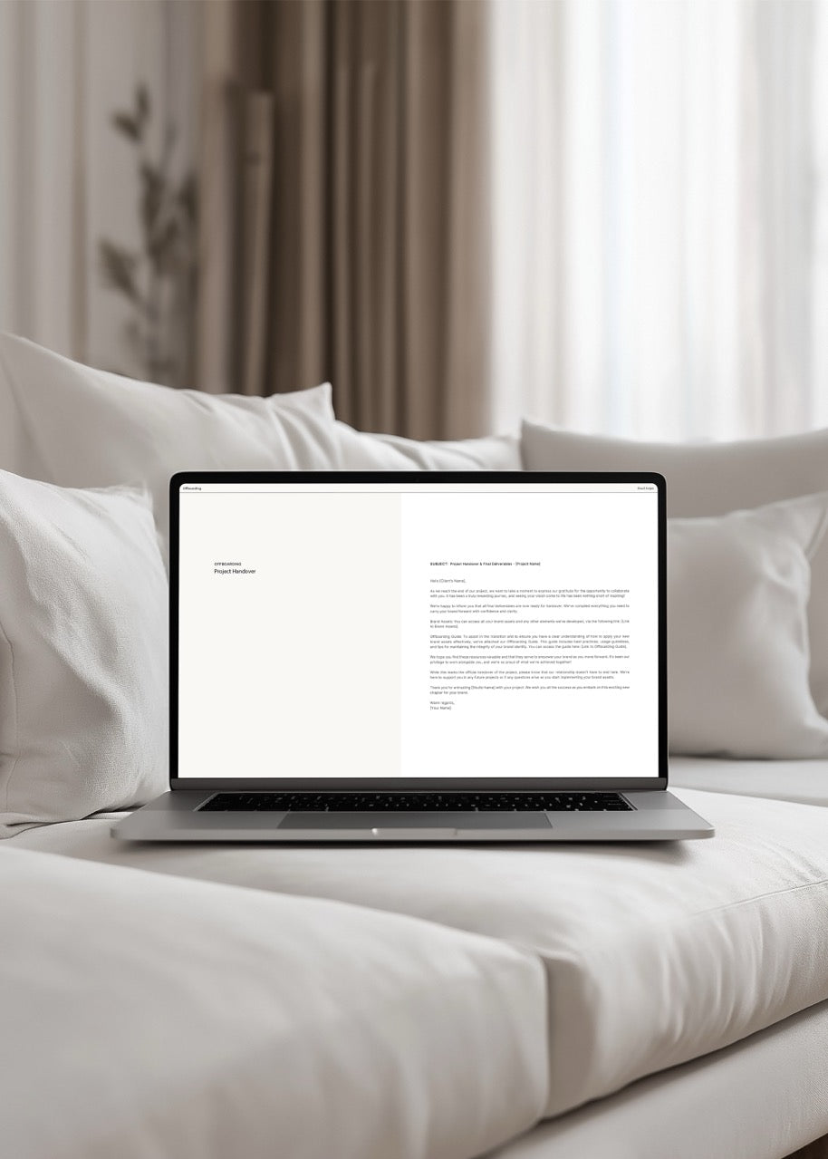 Laptop on a bed with a white screen displaying email communication scripts for designers