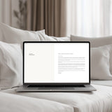 Laptop on a bed with a white screen displaying email communication scripts for designers