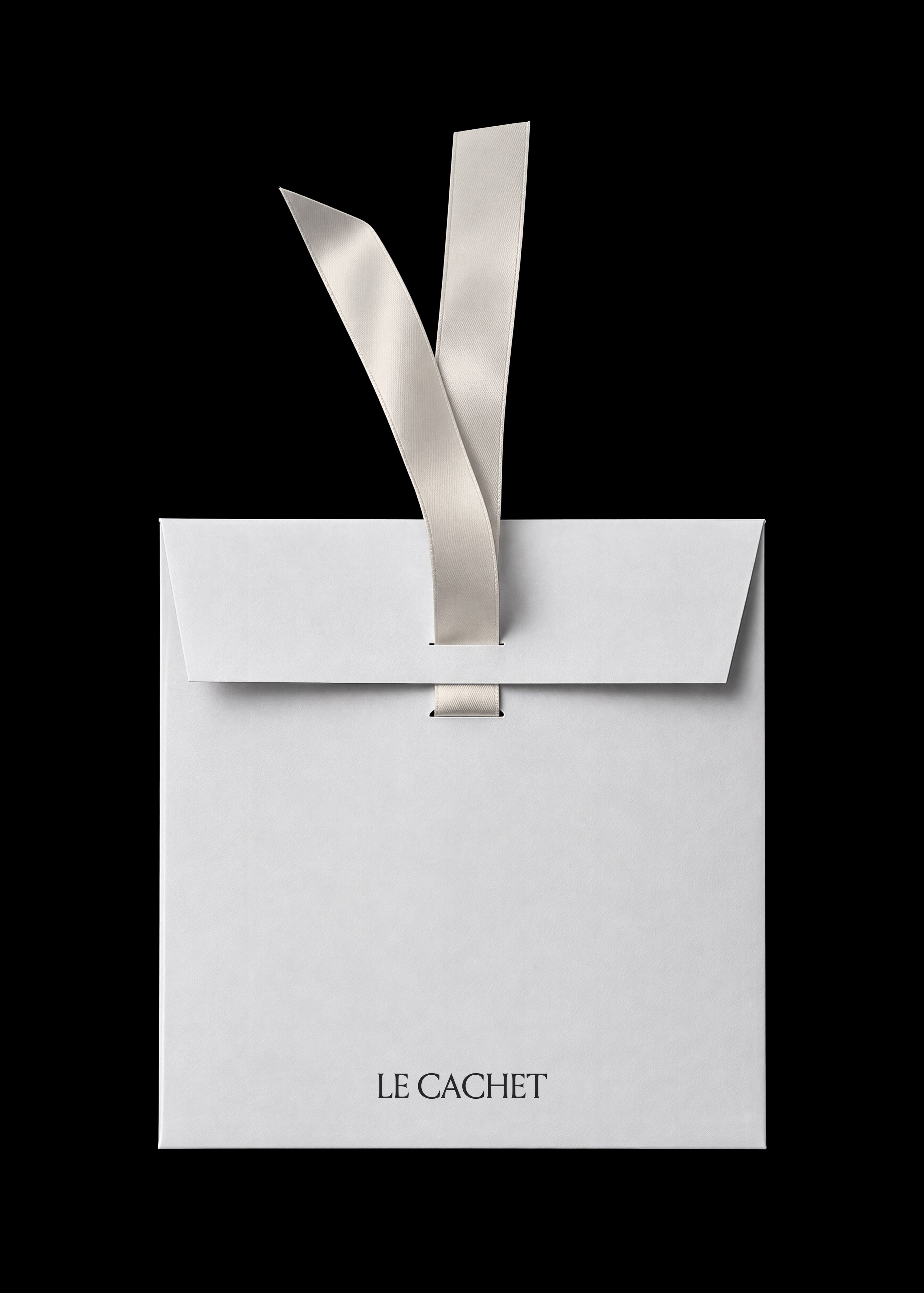 Paper envelope mockup in white with cream satin ribbon closure on a black background, minimal editorial styling