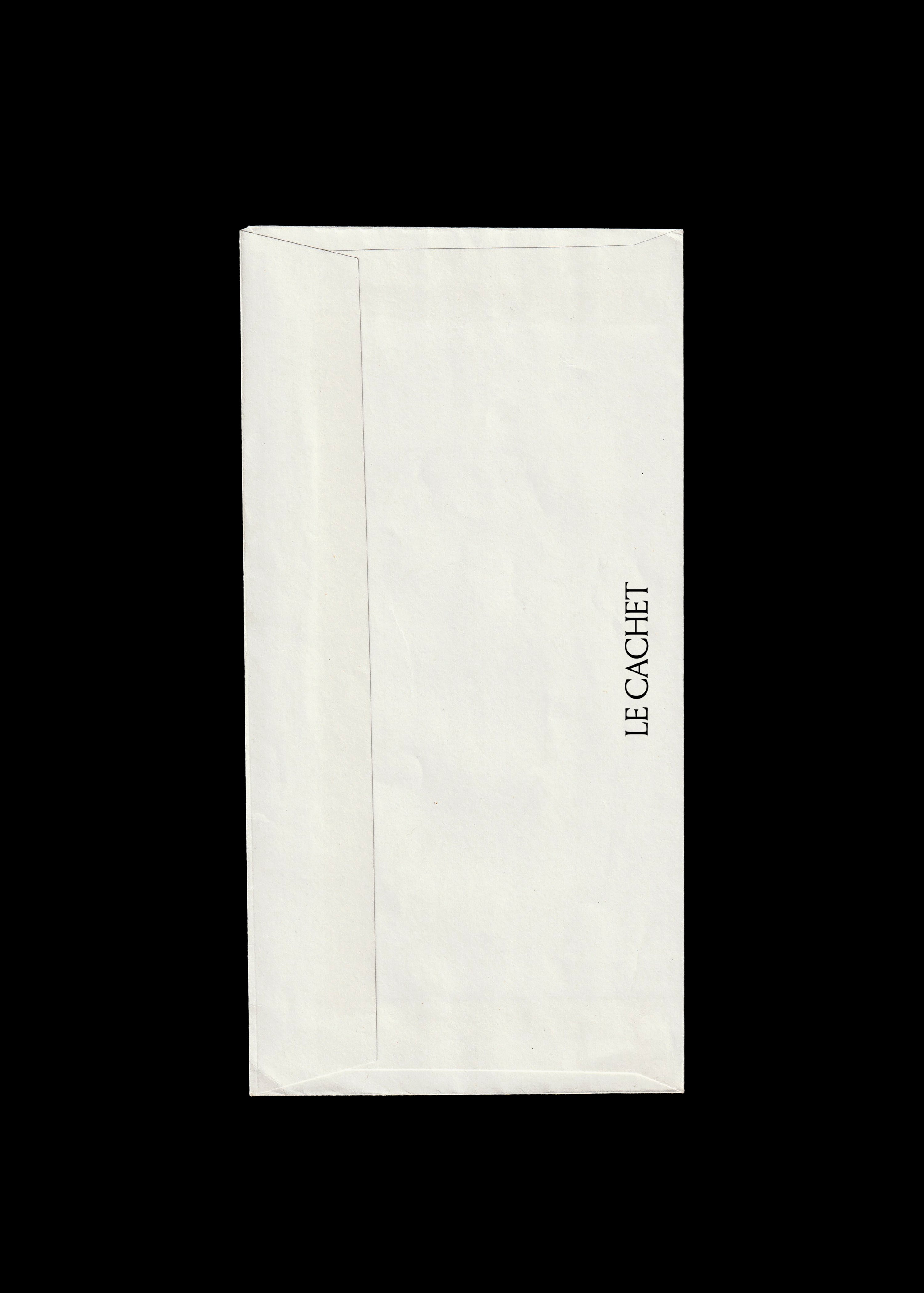 Long white DL envelope mockup scanned flat on black, creased paper back with vertical serif brand name