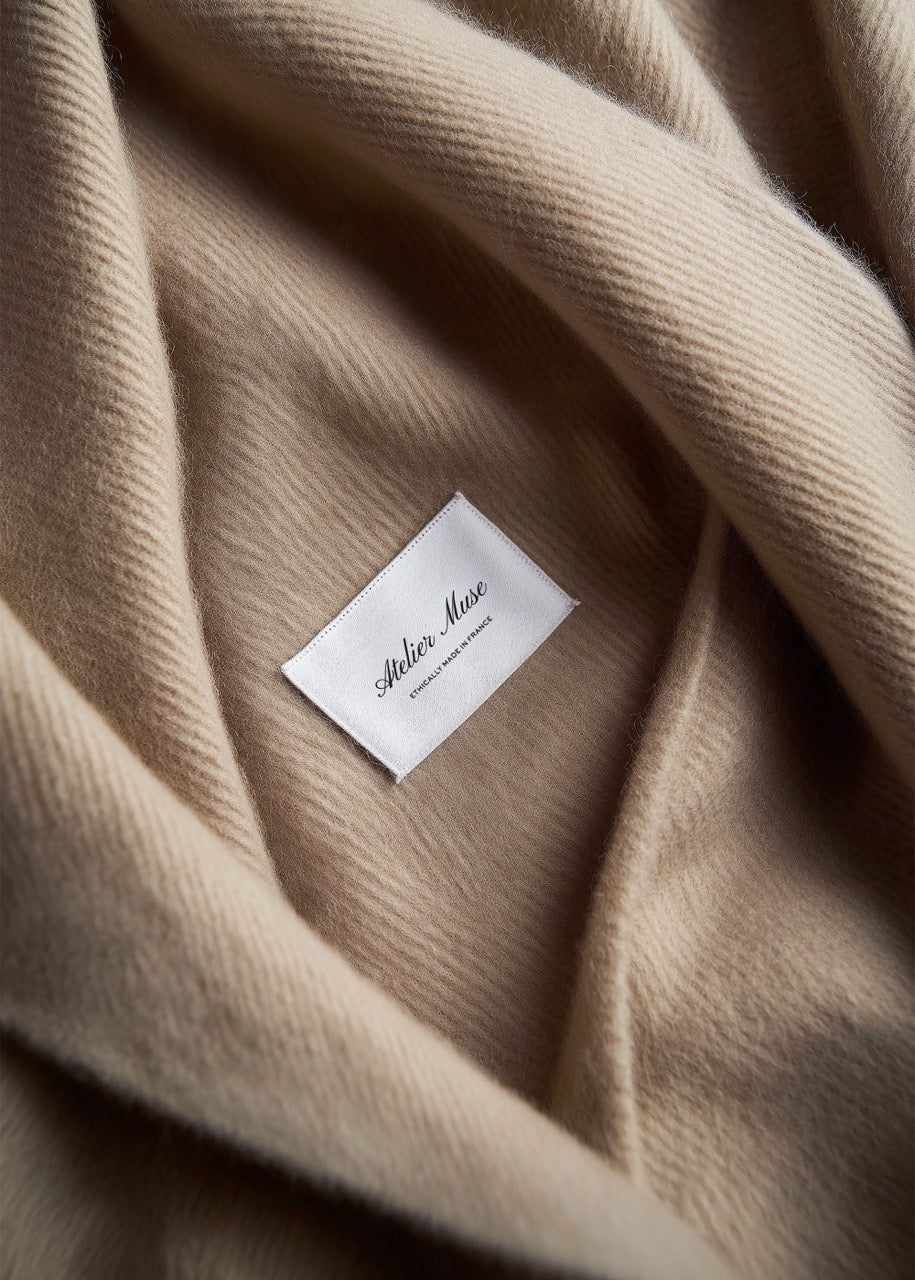Close-up of a beige fabric with a label mockup on it