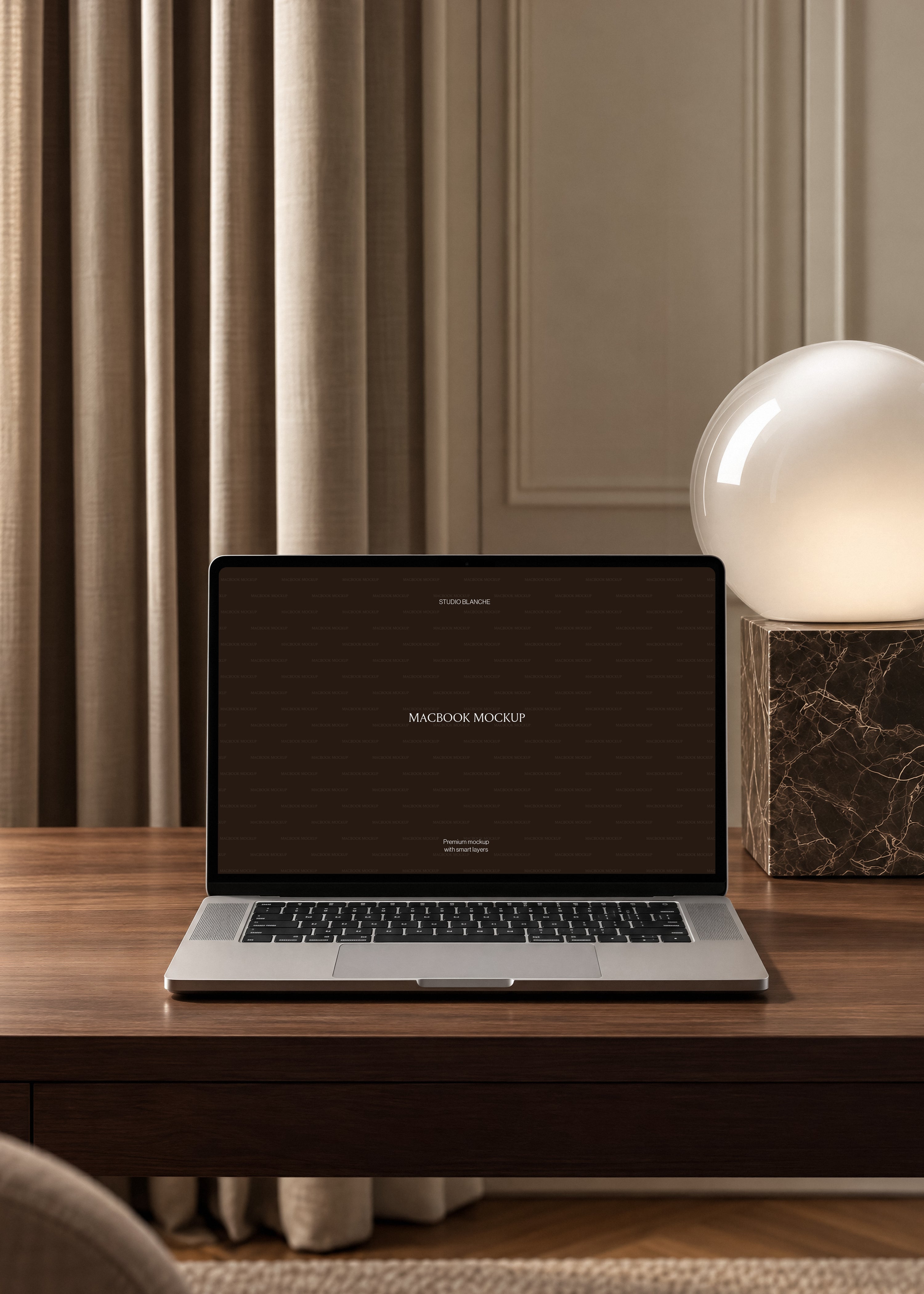 MacBook mockup on warm oak desk beside dark marble globe lamp, pleated curtains and moulded wall panelling